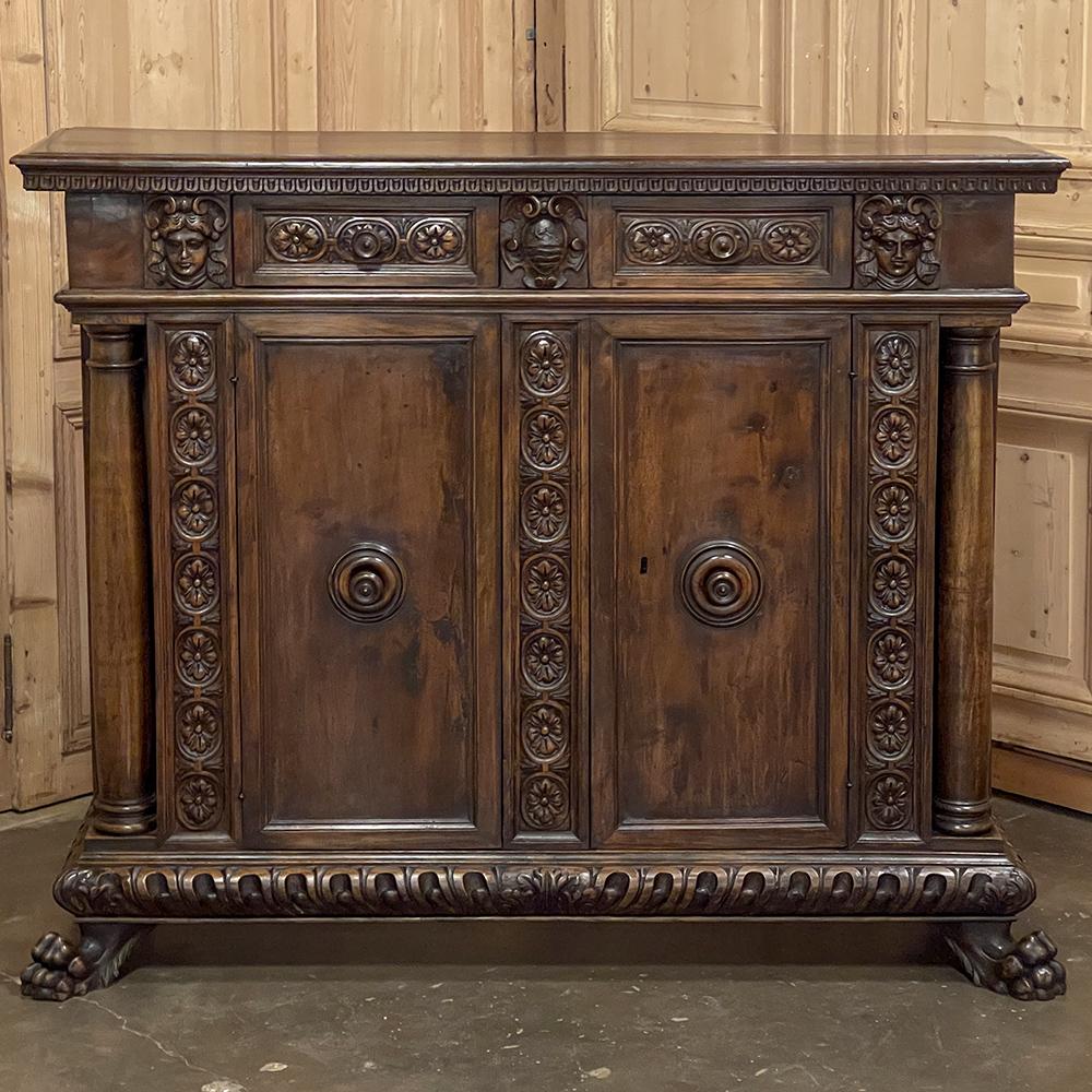 Early 19th Century Italian Walnut Renaissance Revival Buffet is a superlative combination of classical architecture inspired by the ancient Greeks and Romans melded with stylish embellishments inspired by the Renaissance. Crafted on a tall scale, it