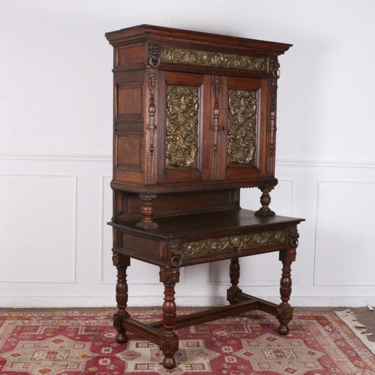 Early 19th Century Jacobean Style Desk & Hutch. This is a very interesting piece. It has exquisite carving and detail. There are brass panels with hunting scene of birds and dogs. Constructed of solid oak. dates back to the early 19th