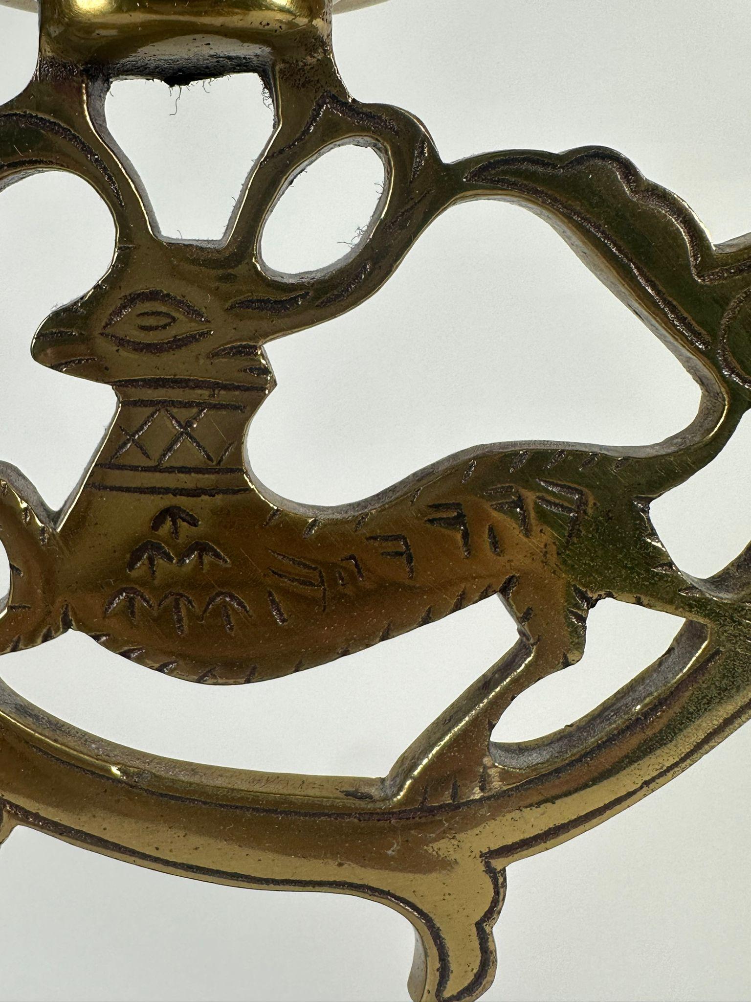 This pair of exquisitely crafted brass candelabras, originating from 19th-century Poland, embodies the beauty and symbolism of Jewish ceremonial art. Intended for Shabbat candle lighting, they are adorned with Hebrew engravings that read 