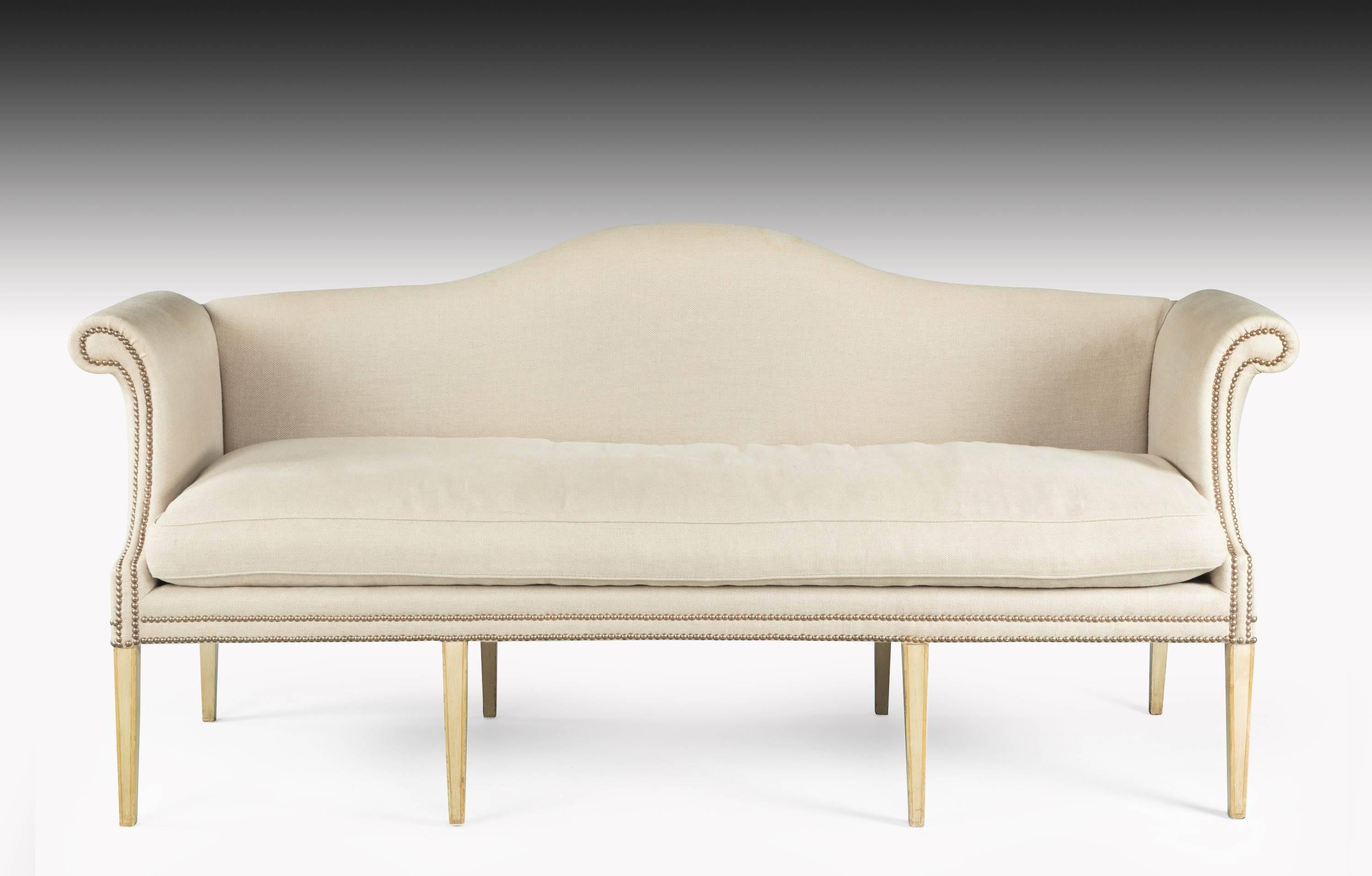 A large camelback sofa, the framework of ivory paint original, but now somewhat tired. 

Measure: Seat height 21 inches.