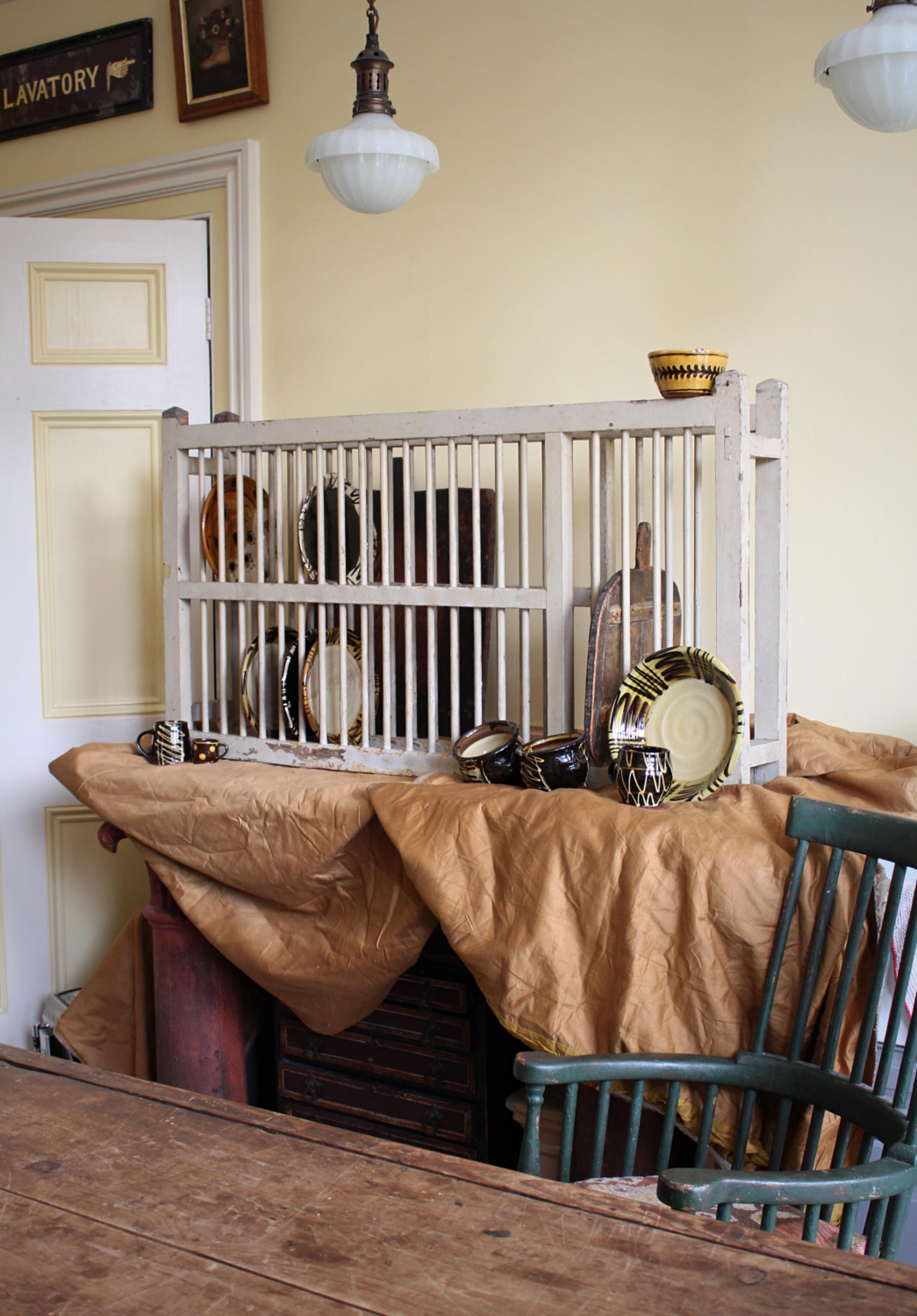 A rare and large early 19th century country house plate rack, still retaining its original painted finish. Of simple construction with plenty of doweled slats for plates bowls and boards.

Beautifully worn from use, sturdy and strong with a handful