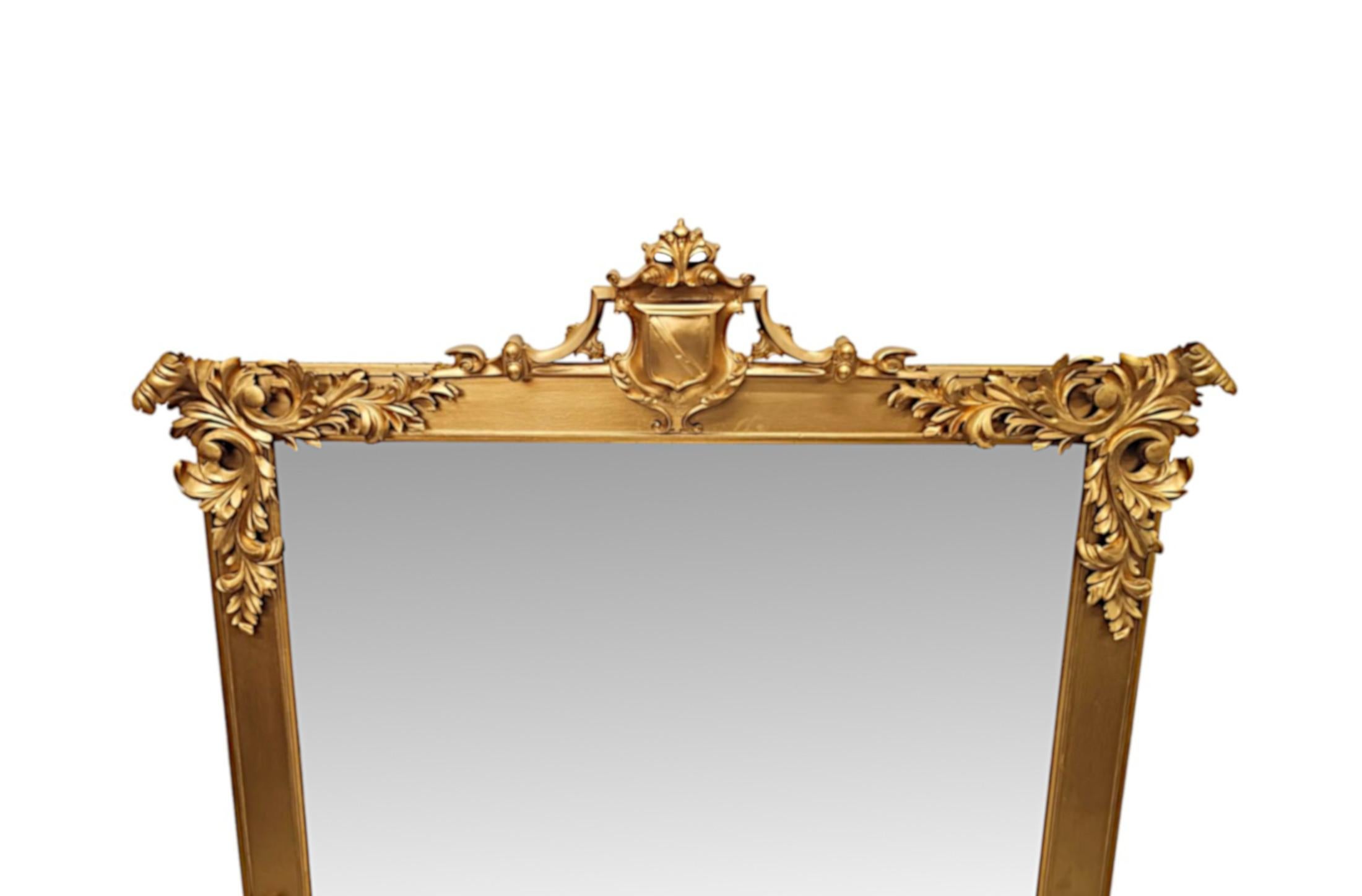 A very fine early 19th Century Irish giltwood overmantel mirror of grand proportions, stunningly hand carved and of exceptional quality.  The original mirror glass plate with some mottling of rectangular form is set within a gorgeous moulded and