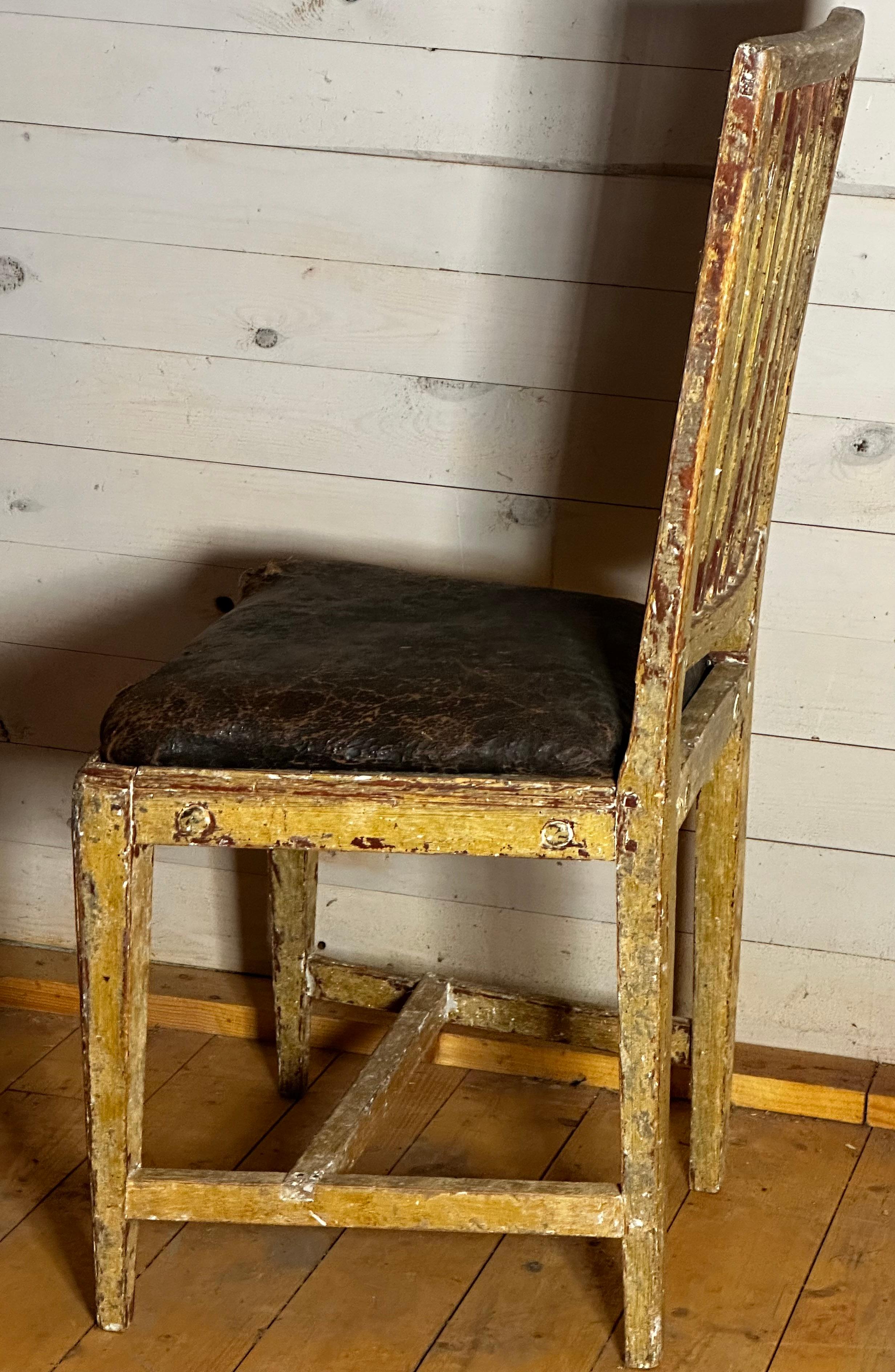Chair made in Sweden about 1800. The original and first secondary color give the chairs surface indigenous textures. The seat is original as well as the leather.
