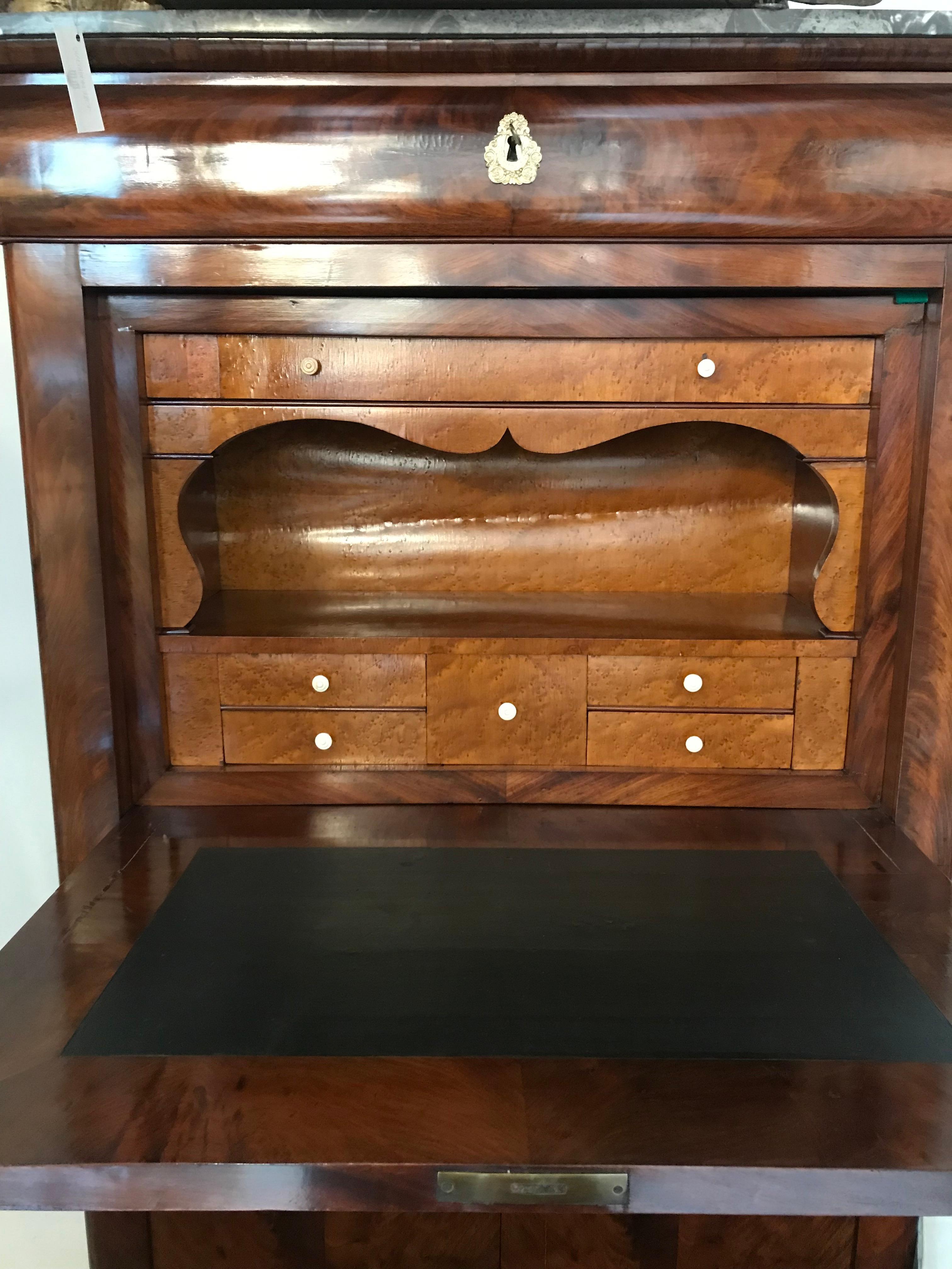 Antique Louis Phillipe Secretary with drop front desk opening to writing desk. Interior is eye maple veneered in the background there are six drawers with small handles. Flames mahogany matched pattern from the bottom doors to the original gray