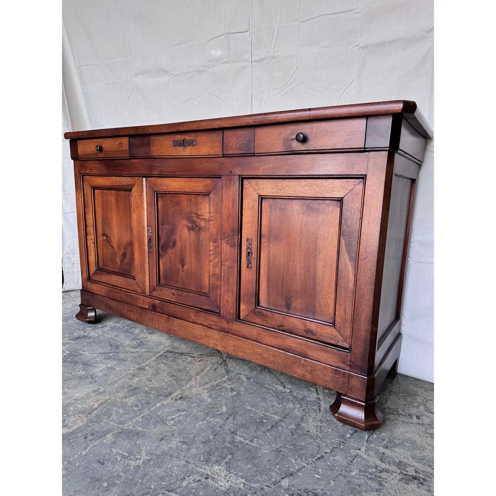 This is a beautifull Louis Philippe French server from the early 19th century in walnut which gives it such a nice warm brown tone. A clean and simple design with three drawers over three doors that both open to ample amount of storage. This would