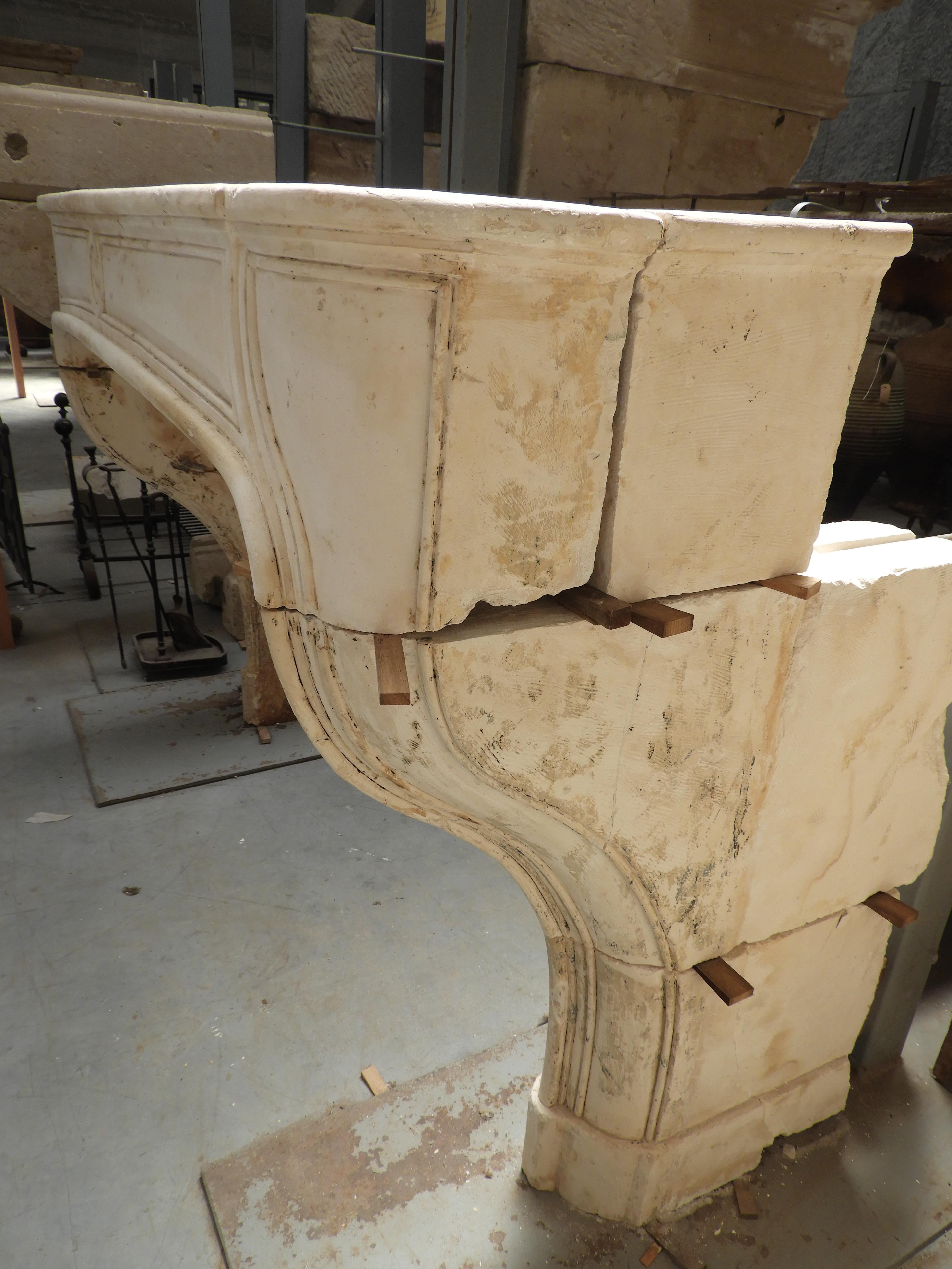 Early 19th century French limestone white or beige fireplace, from the Marne area in France. The paint has been stripped by hand not to damage the surface of the stone to keep it original.