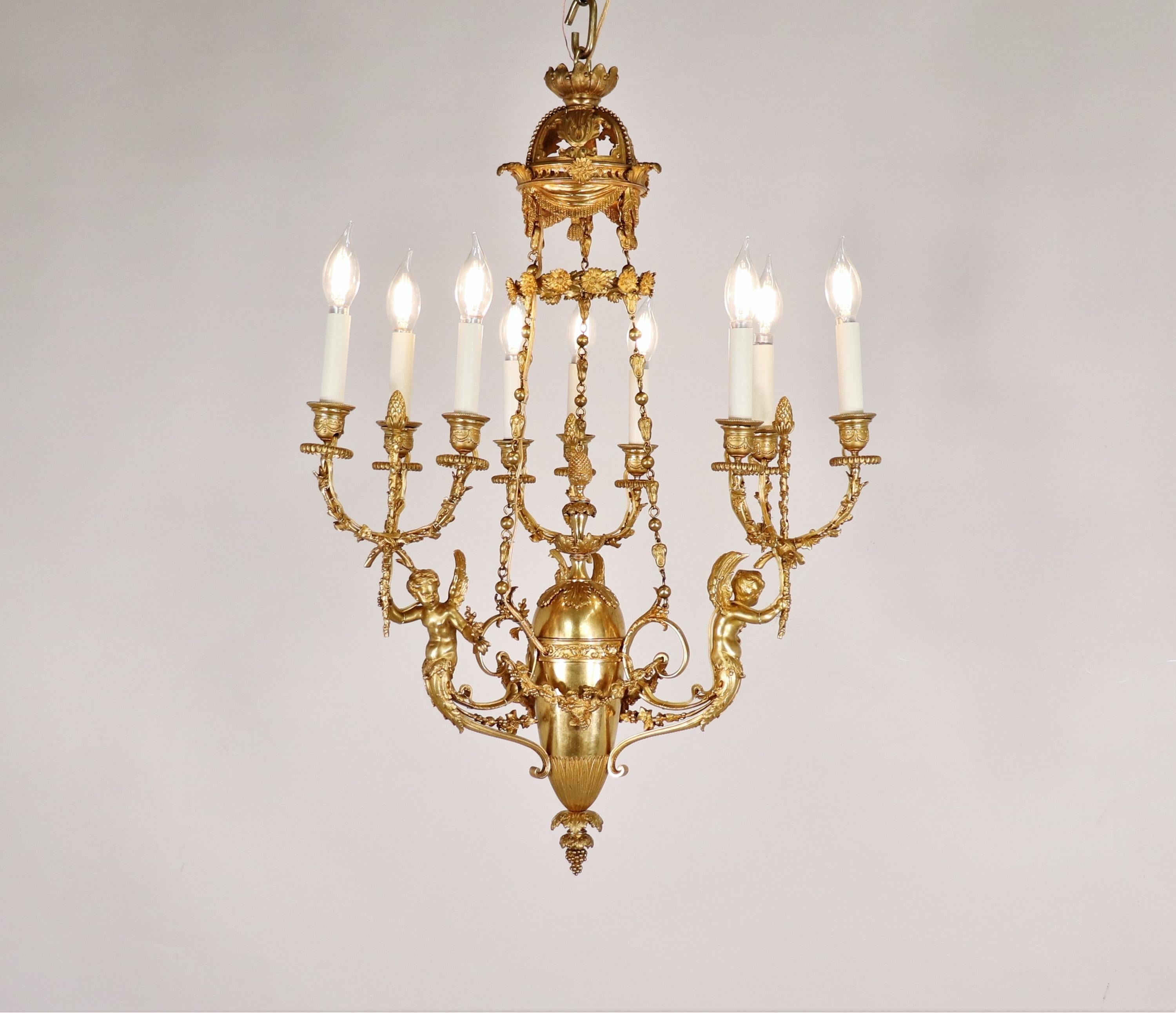 This finely crafted early 19th-century Louis XVI-style ormolu chandelier exemplifies the elegance and neoclassical influences of the period. Gilt in gold, the chandelier is in amazing condition, showcasing the luxurious finish characteristic of this