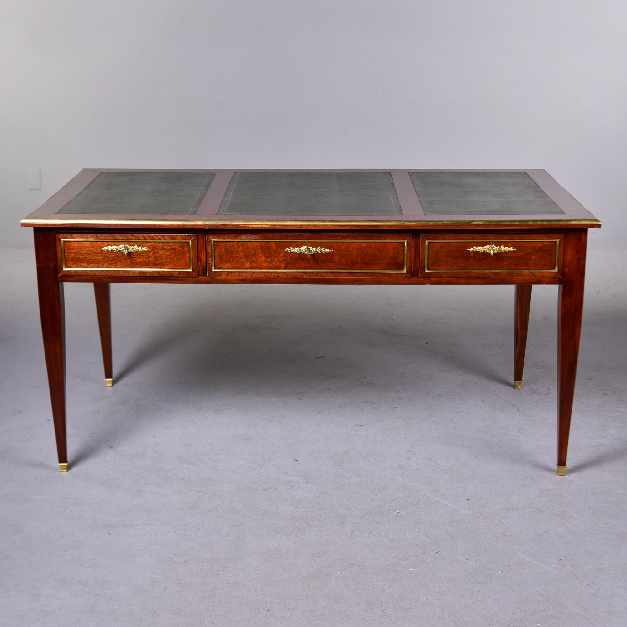 Found in France, this Louis XVI style mahogany desk dates from the 1830s. Generously sized at over five feet wide, this desk is finished on both sides and can float in a room. Front has three dovetail construction functional, locking drawers with