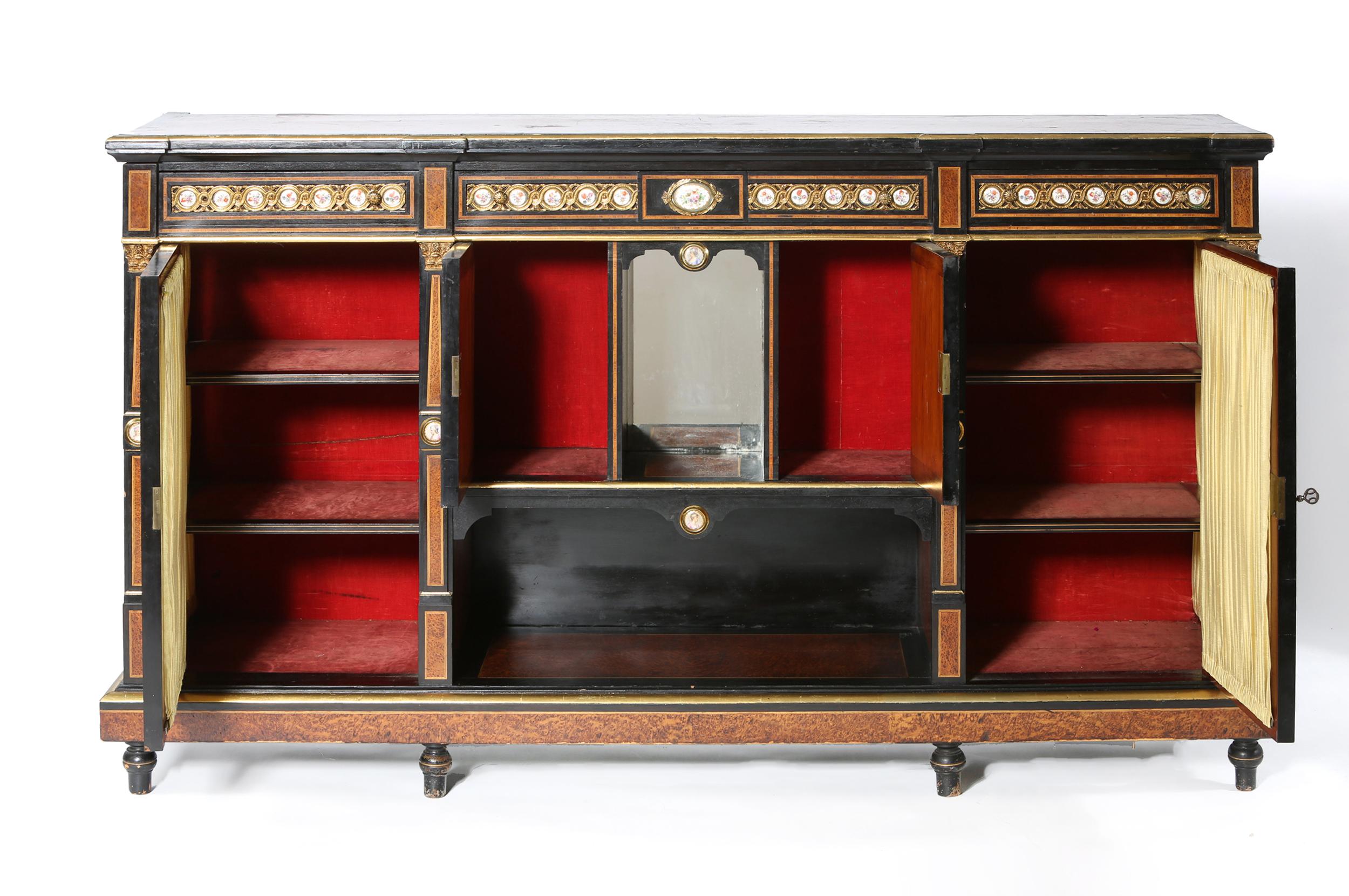 Early 19th century Louis XVI style ebonized fruitwood parquetry with inlaid porcelain and inserted guilloche gilt brass insert. The front of cabinet / sideboard has polychrome decorated porcelain plaques centering two portrait plaque inserted at the