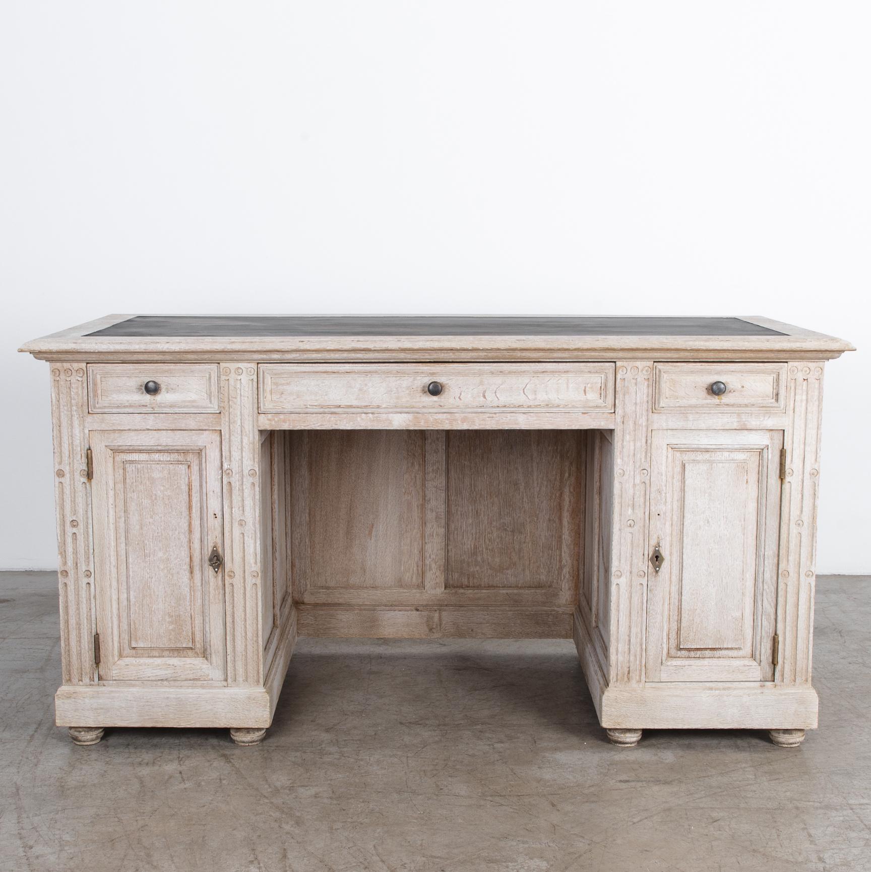 A French desk from circa 1800. Crisp geometry is rendered with traditional
carpentry techniques in this elegant design. Carved with distinctive geometric
ornament, and resting on round wooden feet. A light finish highlights the wood’s
texture and