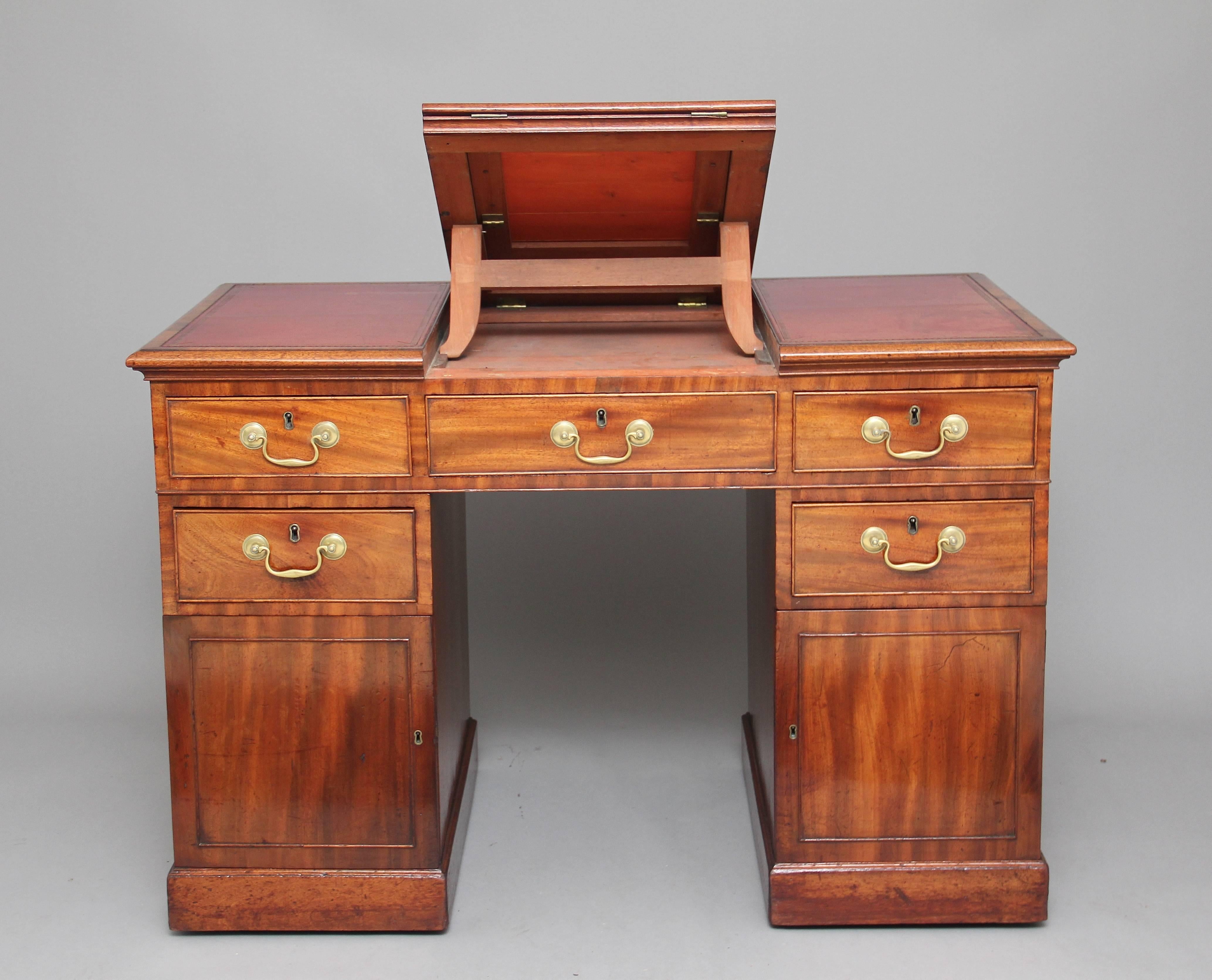 A rare early 19th century mahogany architects twin pedestal desk, the three section top having a red leather writing surface decorated with gold tooling, the middle section having a lift up ratchet mechanism which serves as an architects reading /