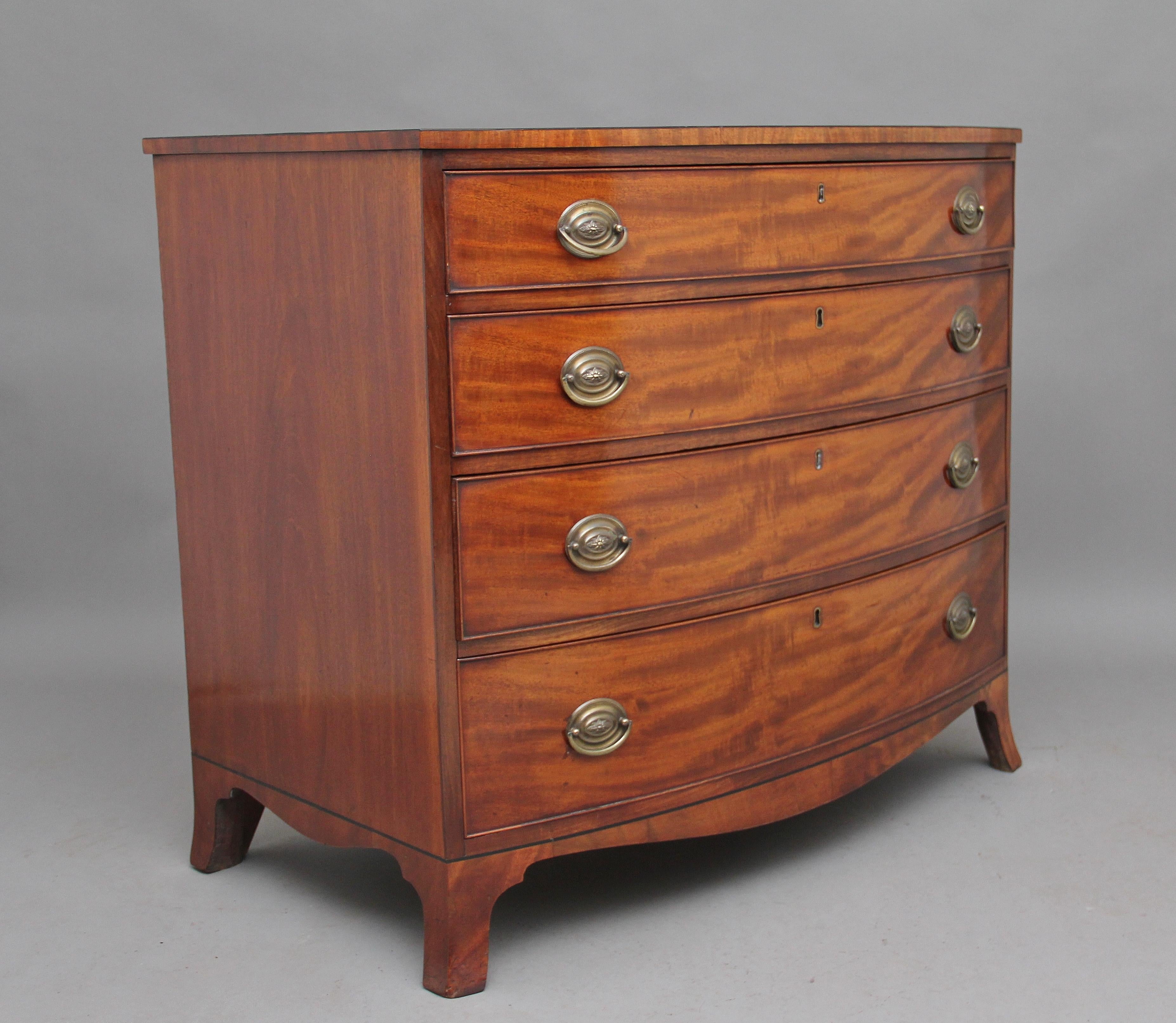 Early 19th century mahogany bow front chest of drawers, the shaped top above four oak lined graduated drawers with oval brass handles, shaped apron to the sides and front, standing on splay feet, circa 1810.
 
