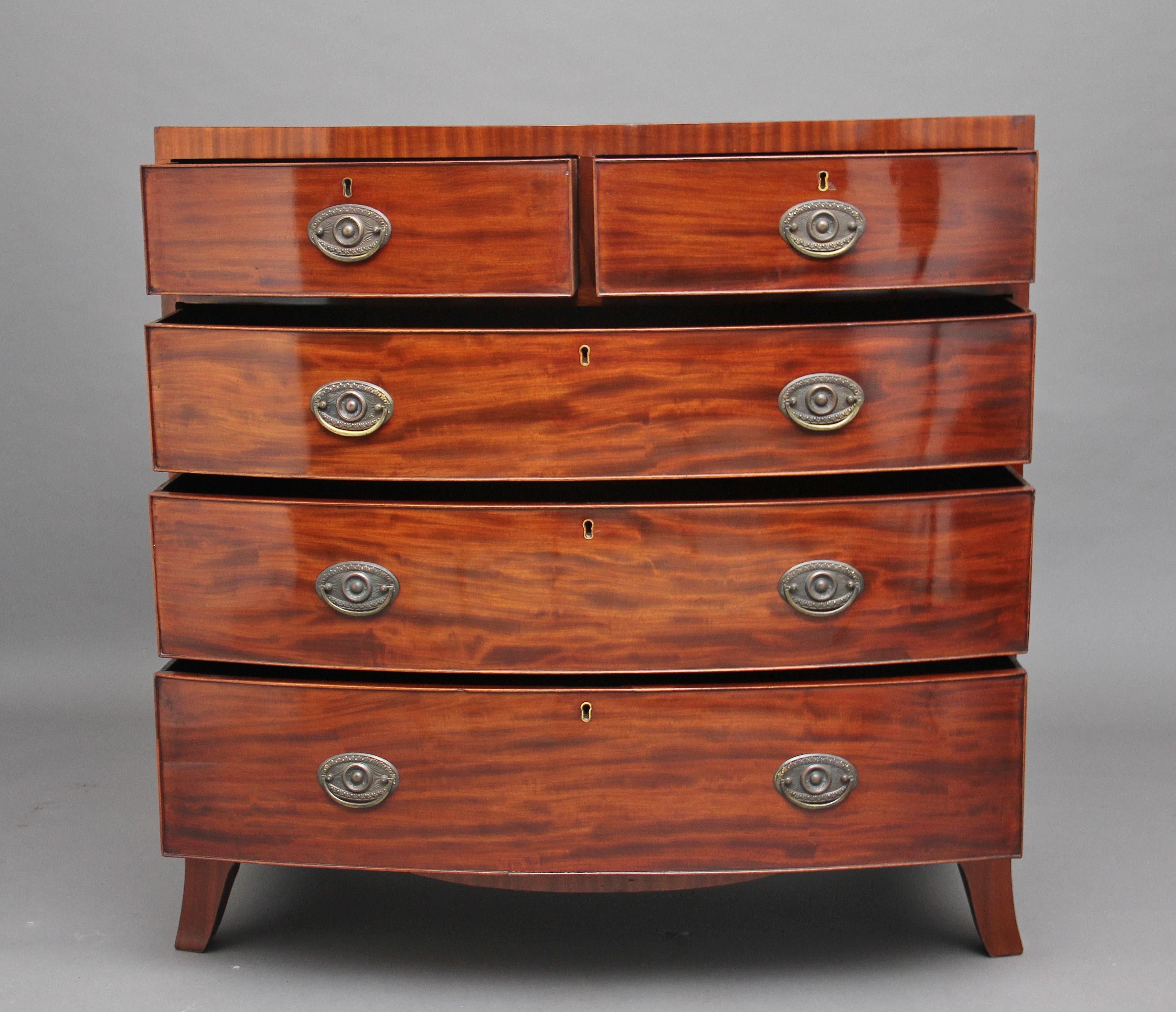 Early 19th century mahogany bowfront chest of drawers, having two short over three long graduated, oak lined drawers with brass oval plate handles, having a nice shaped apron supported on splay feet, circa 1810.
 