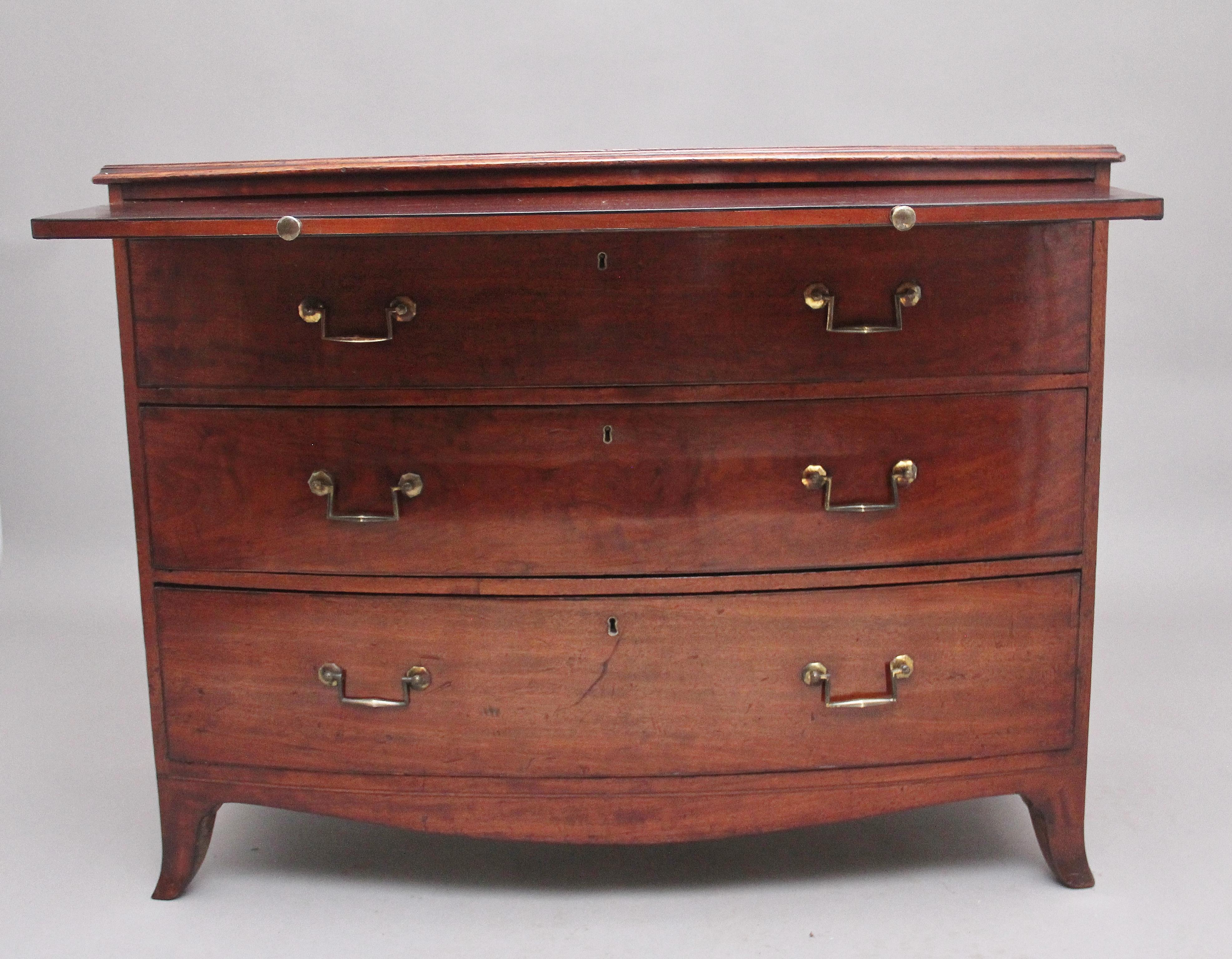 A superb quality early 19th Century mahogany bowfront chest, having a nice figured moulded edge top above a brushing slide, three deep drawers below with the original decorative brass handles, shaped apron, standing on splay feet. Circa 1800.
 