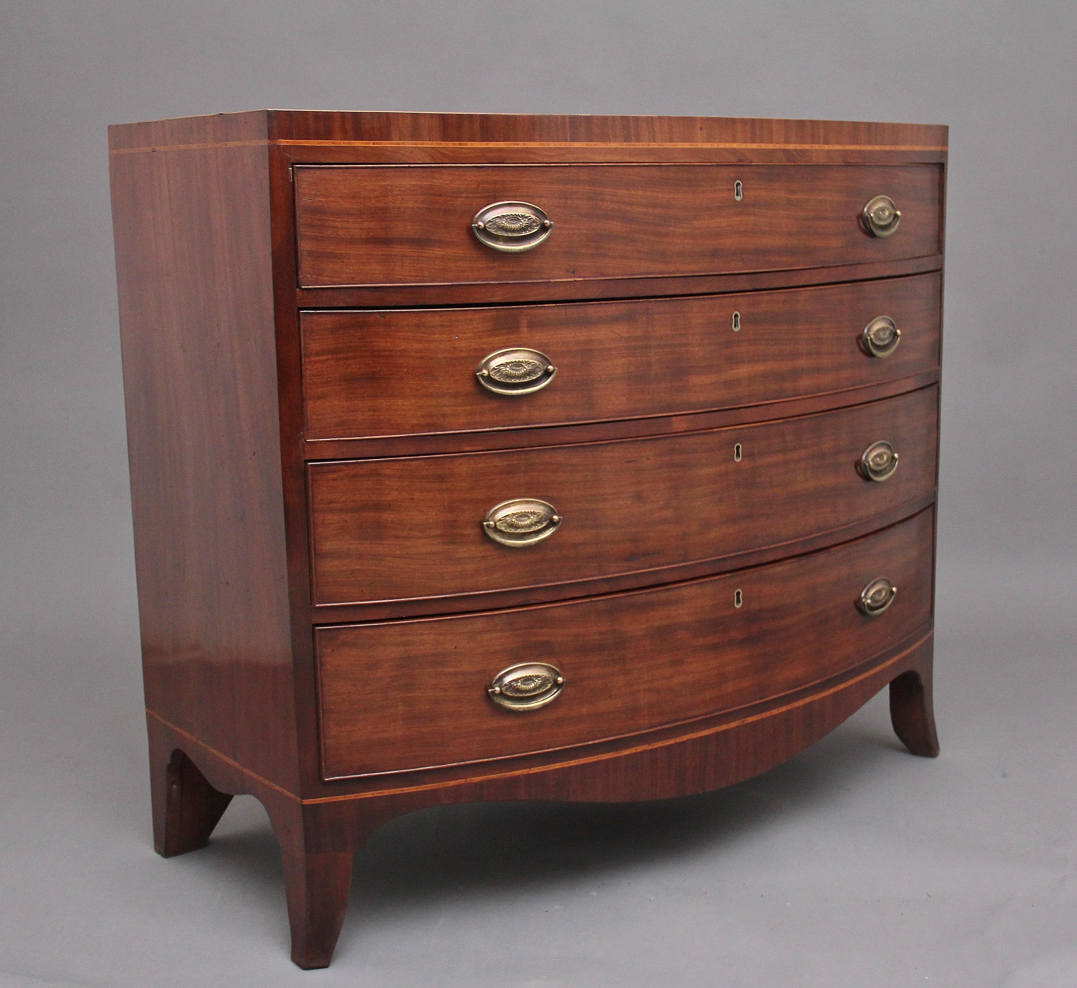 Early 19th Century mahogany bowfront chest of drawers of nice proportions, having a lovely crossbanded figured top above four long oak lined graduated drawers, with oval brass plate handles, shaped apron on the front and sides, supported on splay