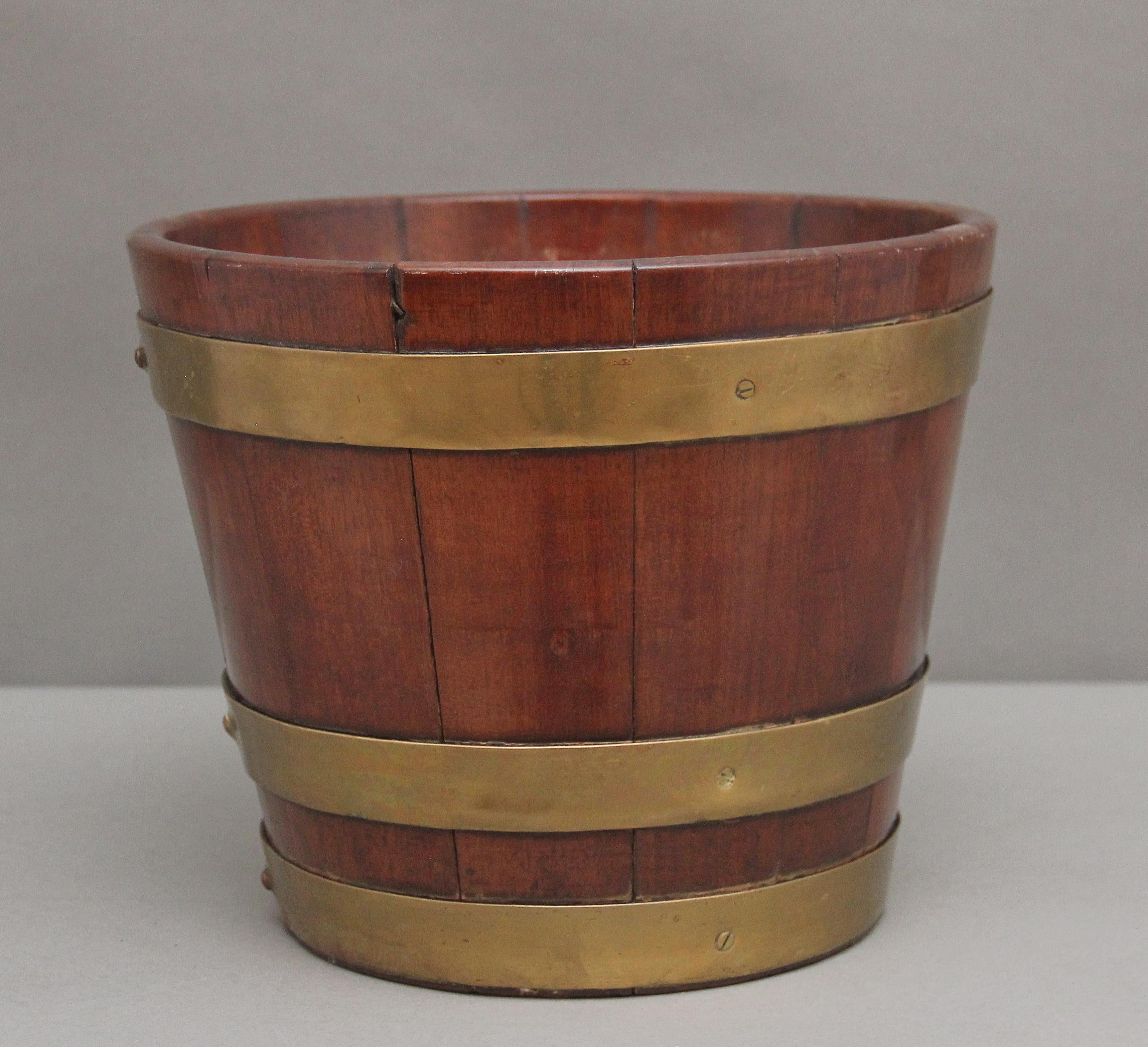 Early 19th Century mahogany brass bound backet of circular form tapering down towards the bottom, good quality bucket and having a nice warm mahogany colour.  Circa 1830.