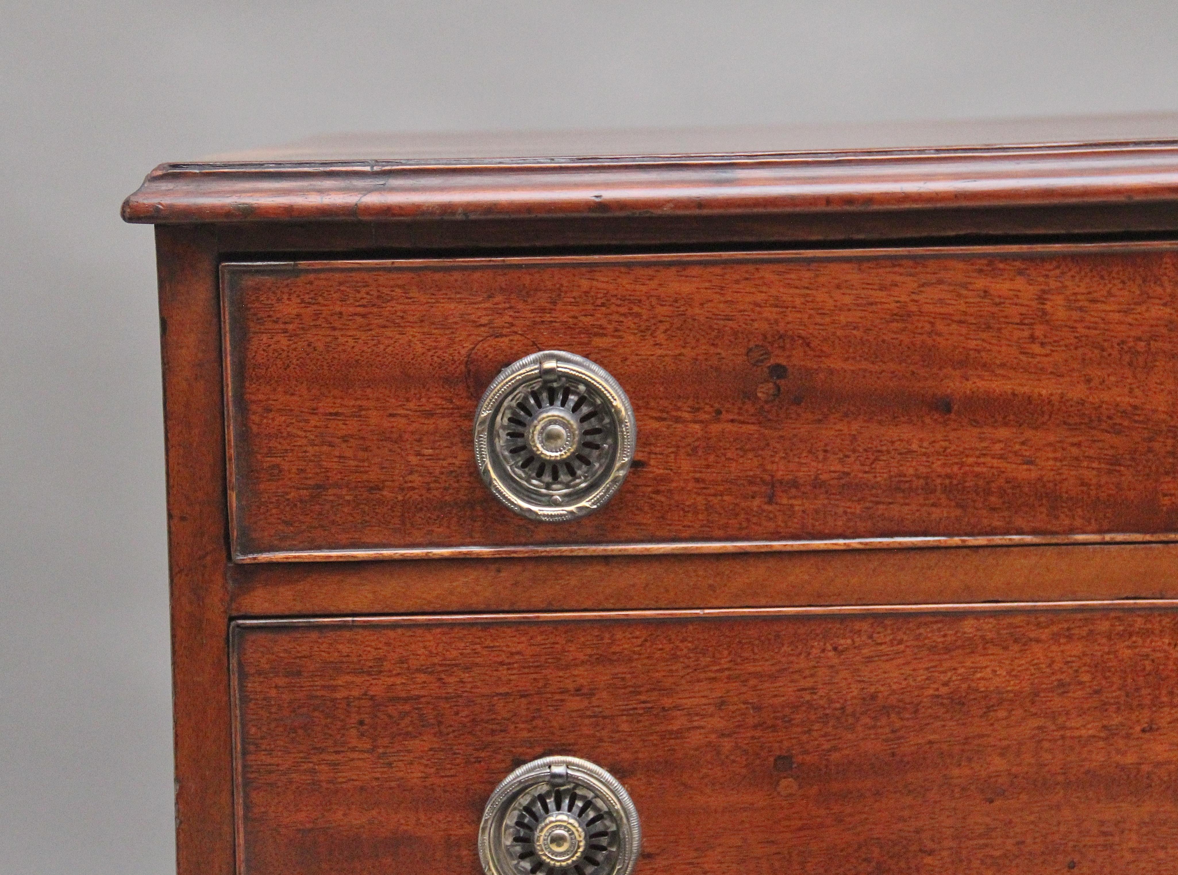 Early 19th Century mahogany chest of drawers, the crossbanded and moulded edge top above a selection of four long oak lined graduated drawers with pierced brass ring handles, supported on bracket feet.  Circa 1810.