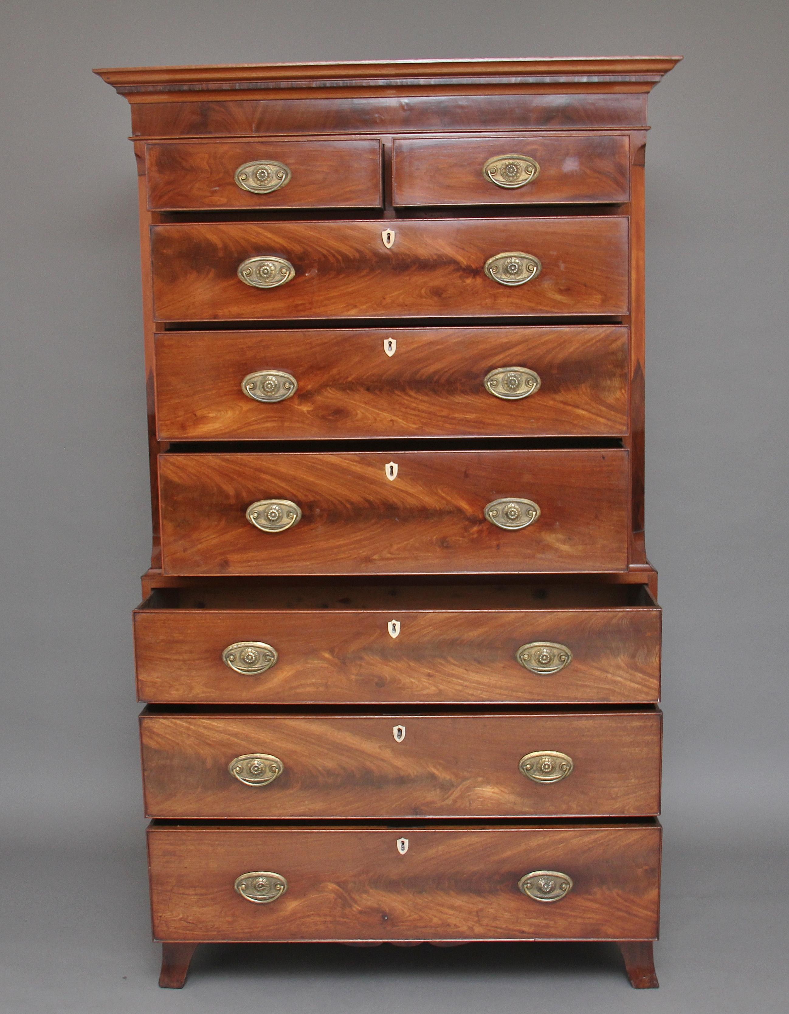 Early 19th century flame mahogany chest on chest, having a molded edge cornice above a selection of eight drawers, two short over six long graduated drawers, which are all oak lined and have original oval brass handles, the top section has canted