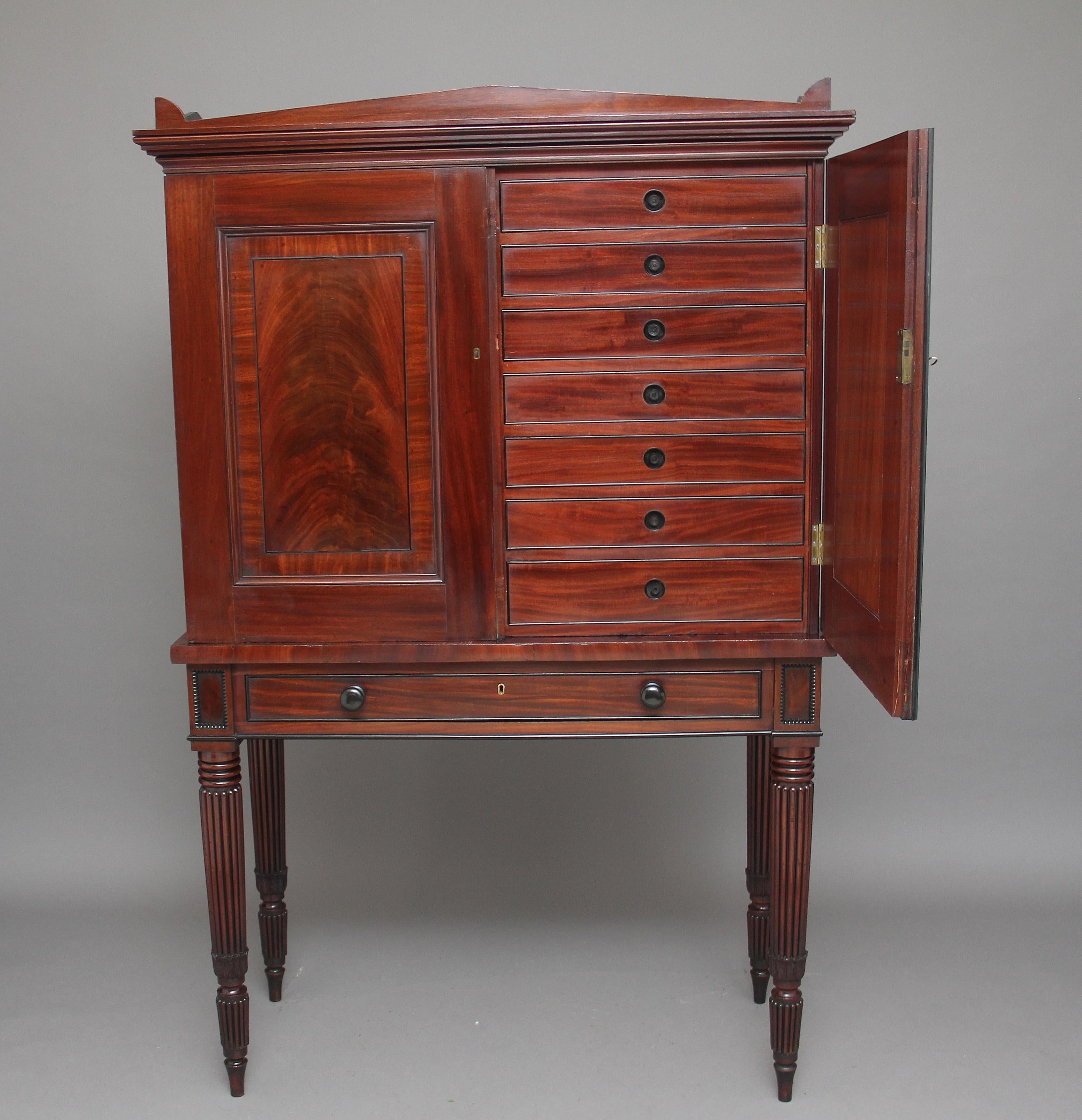 A stunning quality 19th century mahogany collectors cabinet very much in the manner and style of Gillows, the two door top enclosing fourteen oak lined drawers with ebony cock beading and sunken ebony handles, the doors have got curl veneer and