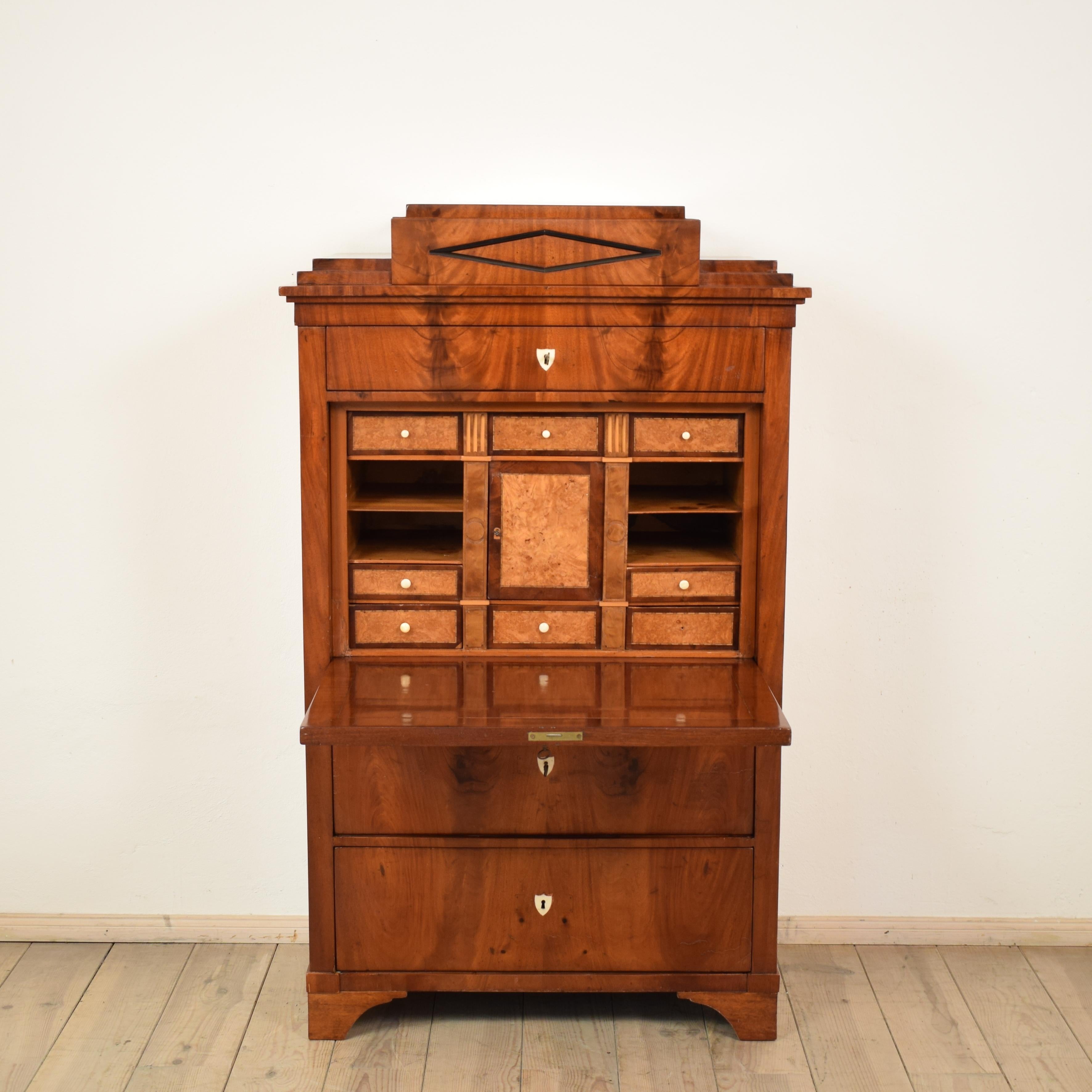 This Empire secretary was made in Germany, circa 1810. It is mahogany veneer on oak.
The inside its veneered in birch.
The architectural design is typical for this period. A very fine furniture which fits into a modern or classical home.