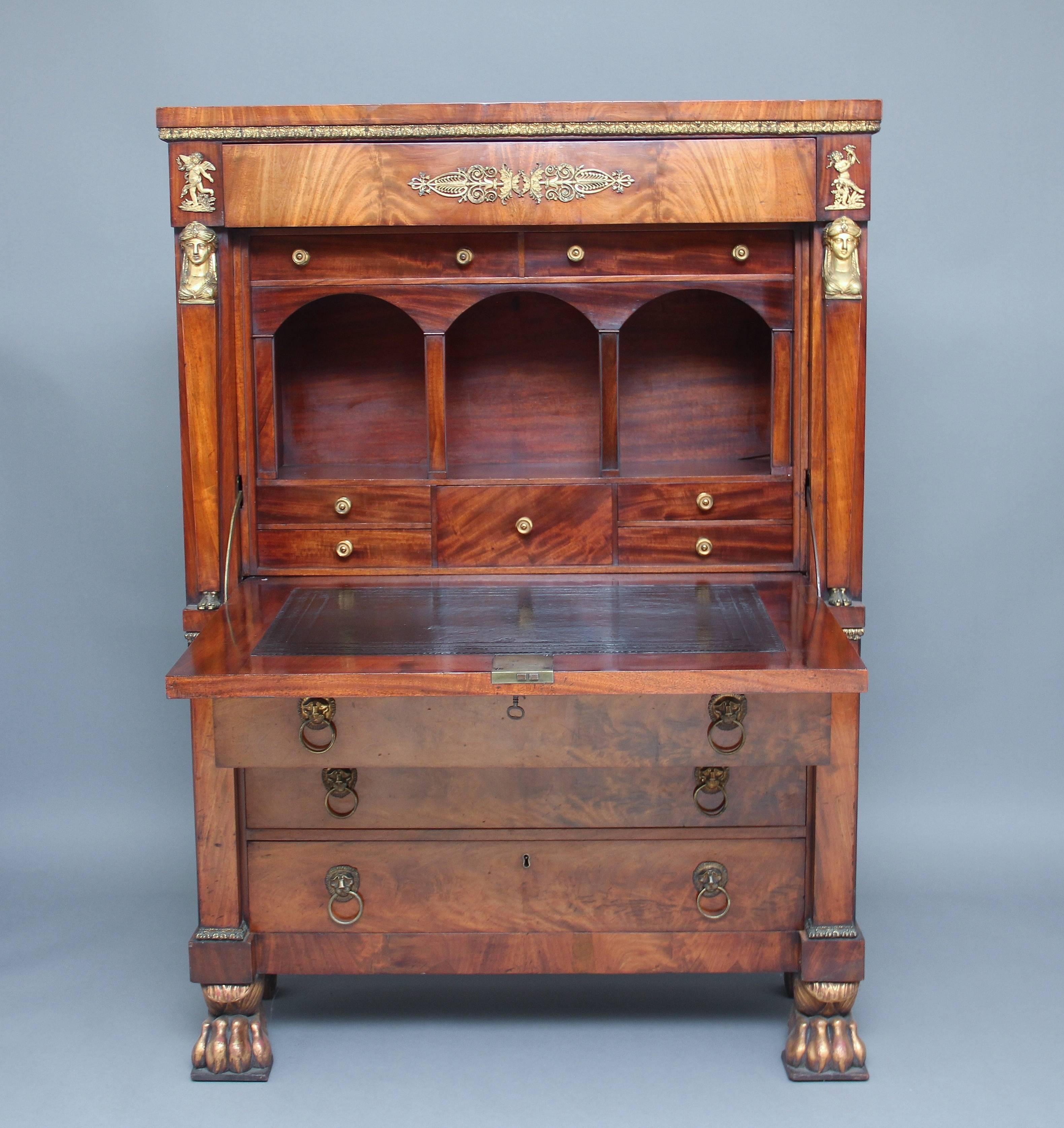 A superb quality early 19th century mahogany escritoire, with ormolu beading running underneath the top along the sides and front, the front of the cabinet having a mahogany lined frieze drawer with ormolu mounts either side, the drop down fall