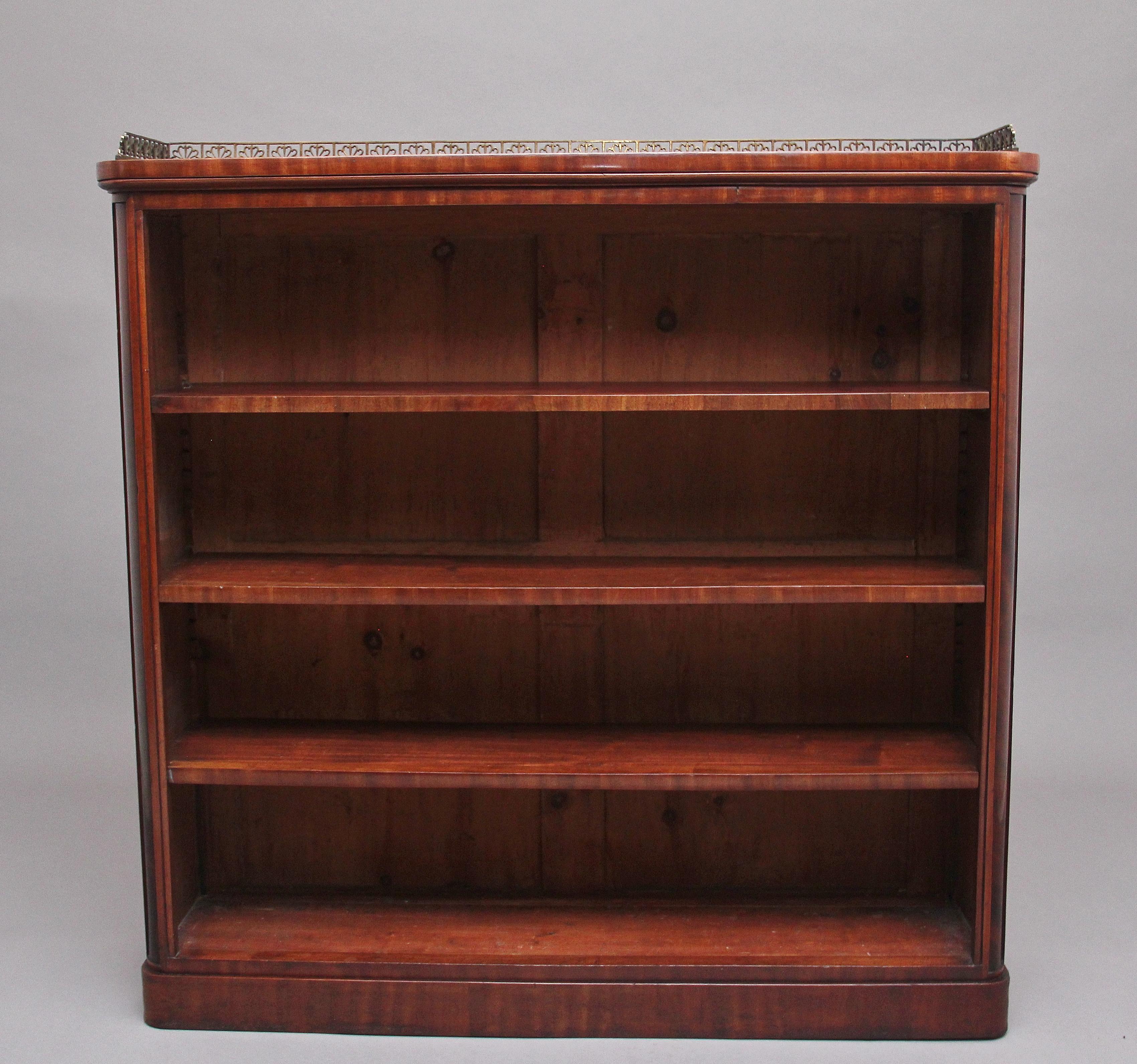 Early 19th century mahogany open bookcase, having decorative three quarter brass gallery on the rounded rectangular top, the bookcase having three adjustable shelves, supported on a plinth base. Circa 1830.