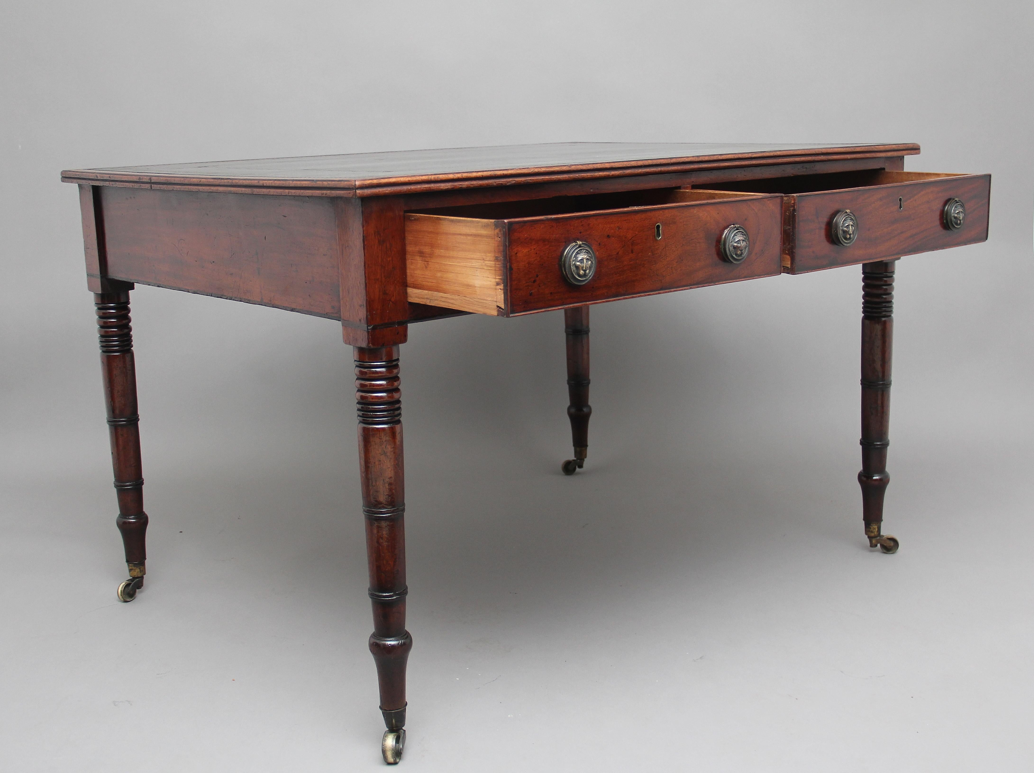 Early 19th century mahogany partners writing table or desk, the top having a green leather writing surface decorated with blind and gold tooling, double D moulded edge, the desk having two drawers at the front and the back, solid drawer linings,