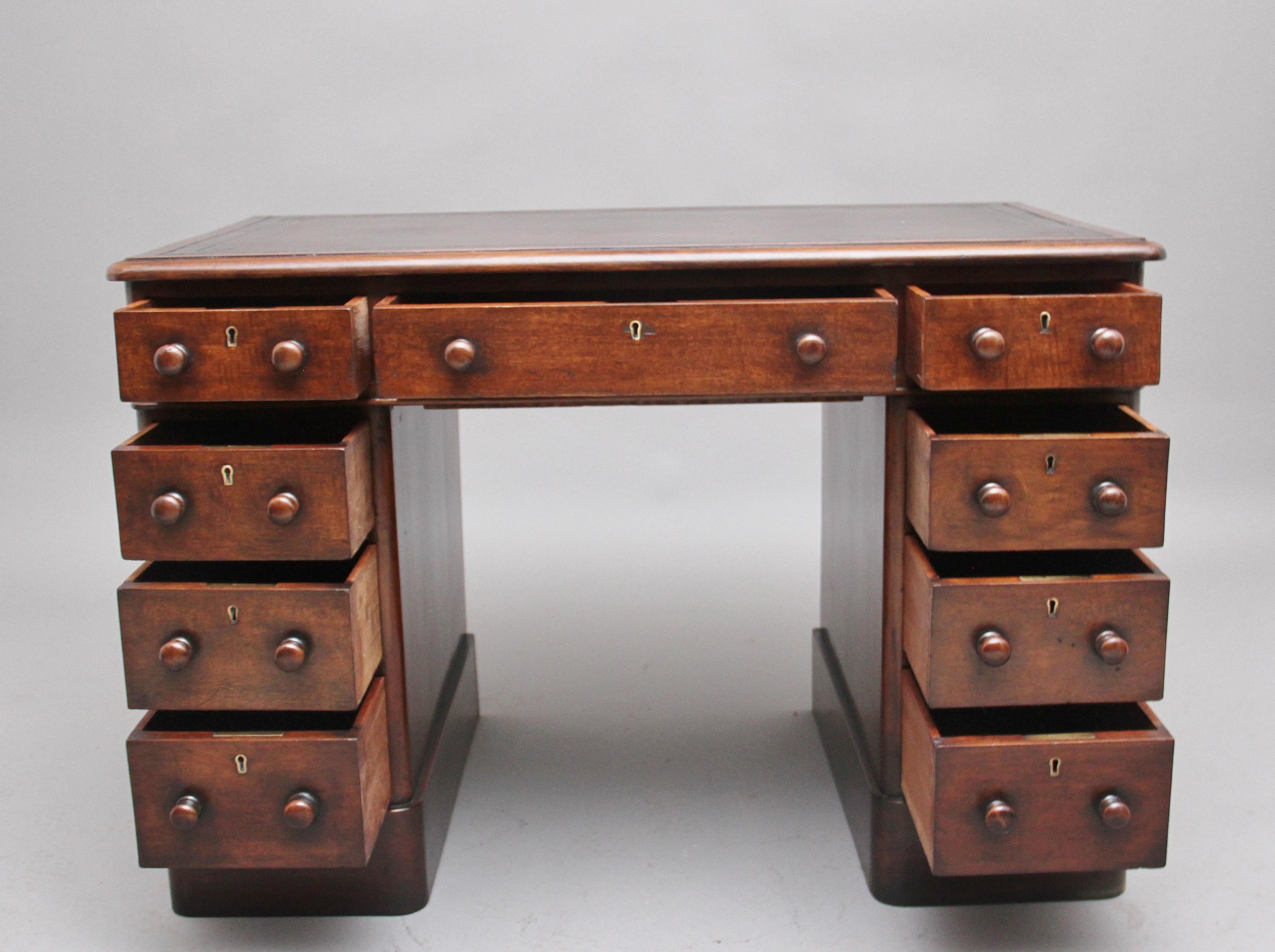 Early 19th century mahogany pedestal desk, the moulded edge top having a brown leather writing surface decorated with gold and blind tooling, the desk has an arrangement of nine graduated mahogany lined drawers with the original turned wooden knob