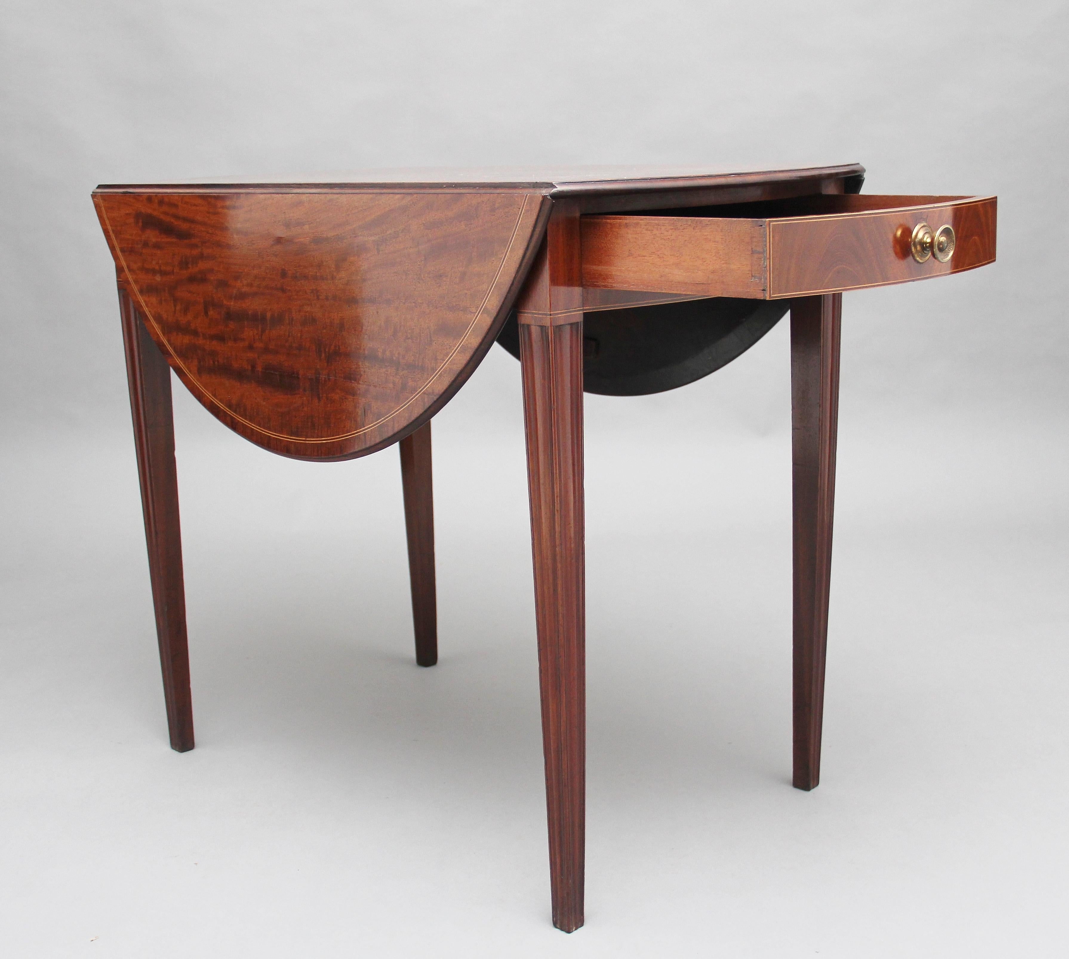 Early 19th century mahogany Pembroke table, the lovely figured drop leaf top with a moulded edge and inlay decoration, a single mahogany lined drawer at one end with a turned brass handle, the drawer front also having inlay decoration, supported on