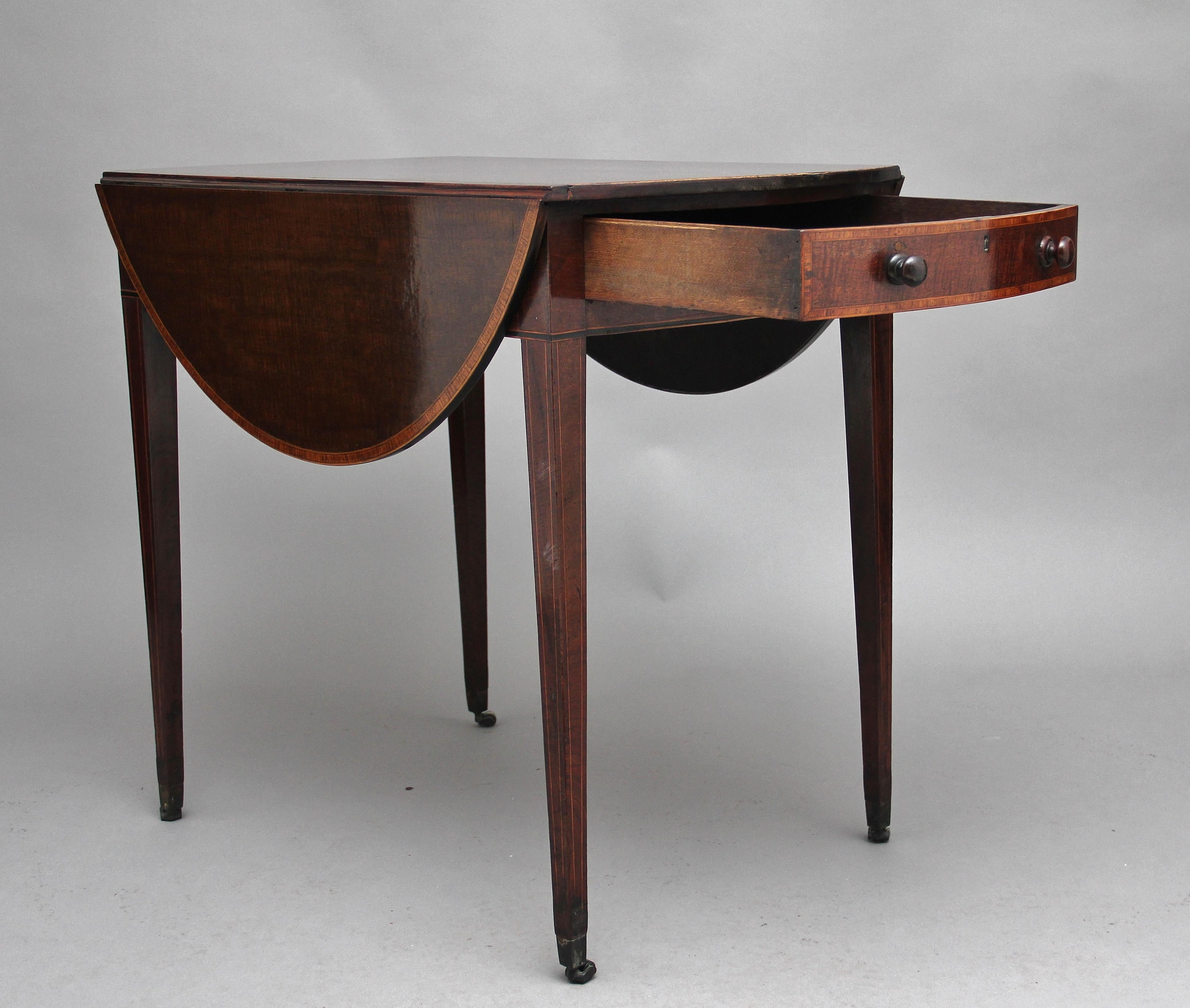 Early 19th century mahogany Pembroke table, the lovely figured, crossbanded drop leaf top, a single oak lined drawer at one end with original turned wooden knob handles, the drawer front also crossbanded, supported on four tapering legs with inlay