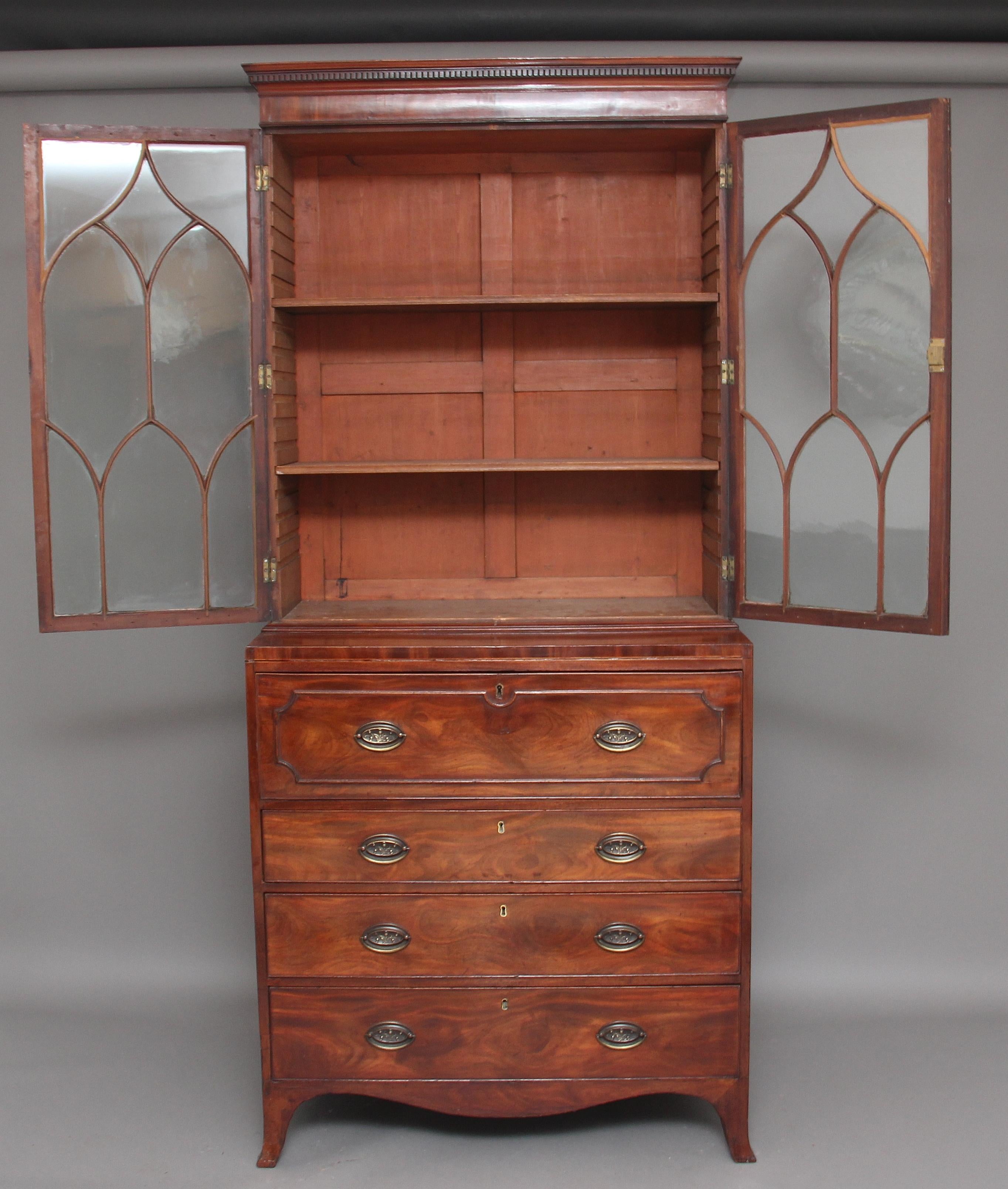 Early 19th century mahogany secretaire bookcase with a nice moulded cornice with dentil moulding, the bookcase having two astrigal glazed doors with two adjustable shelves inside, the bottom section having a pull out secretaire drawer opening to