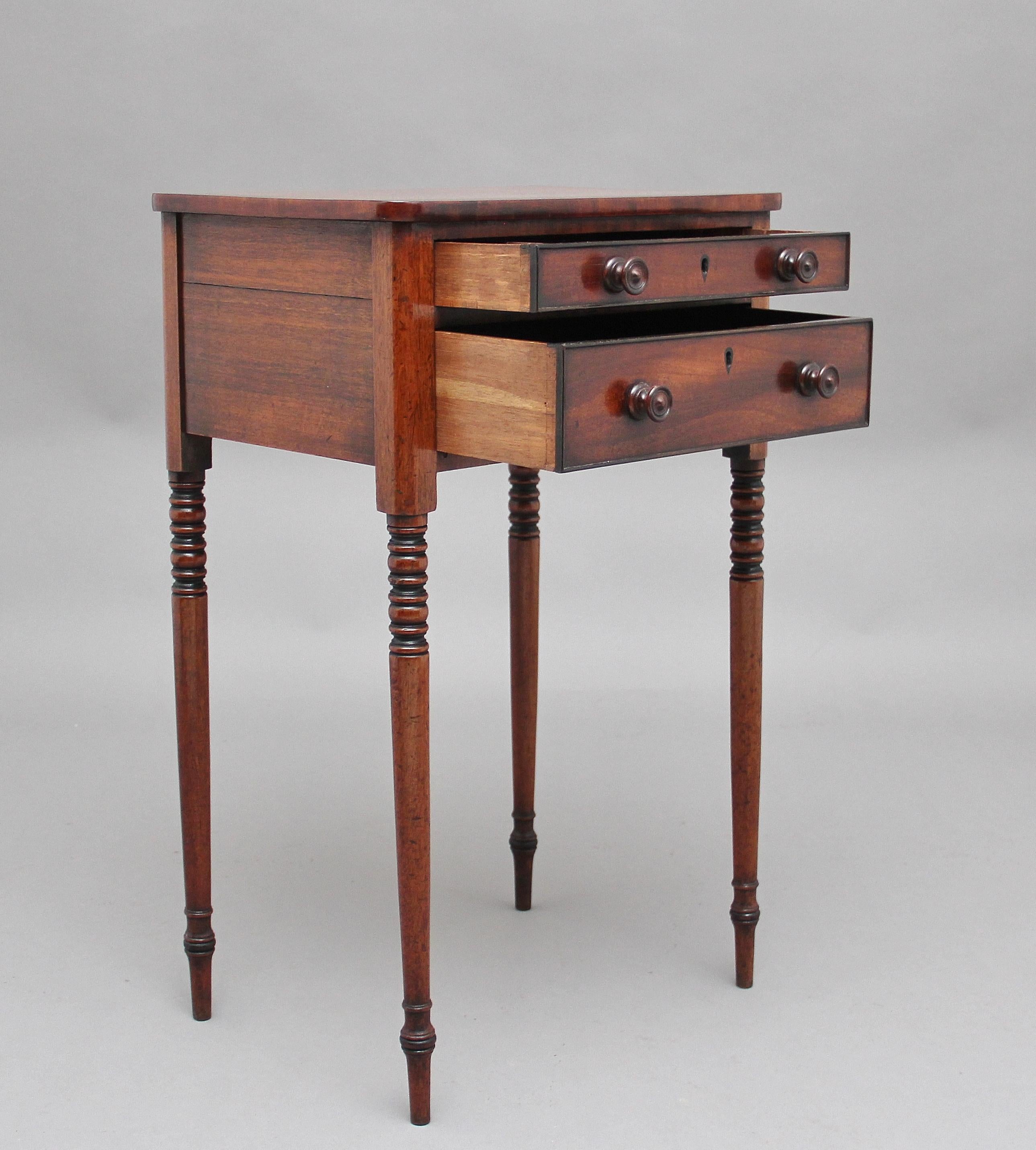 Early 19th century mahogany side or occasional table, the crossbanded top above two drawers of different depths, both oak lined and having original turned wooden knob handles, supported on elegant turned legs, circa 1830.