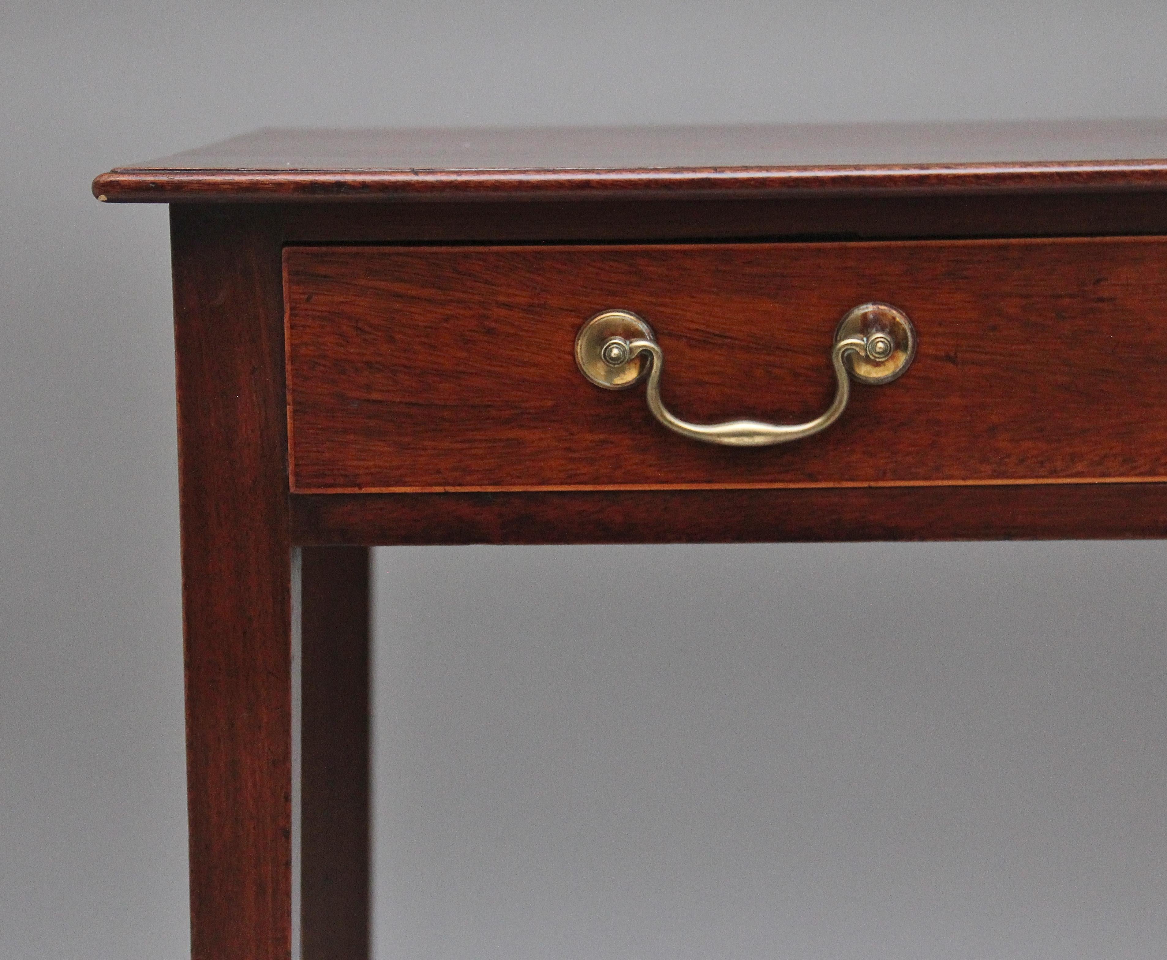 Early 19th Century mahogany side table, having a wonderfully figured top with a moulded edge above a single drawer with brass swan neck handles, supported on square tapering legs.  Circa 1810.
