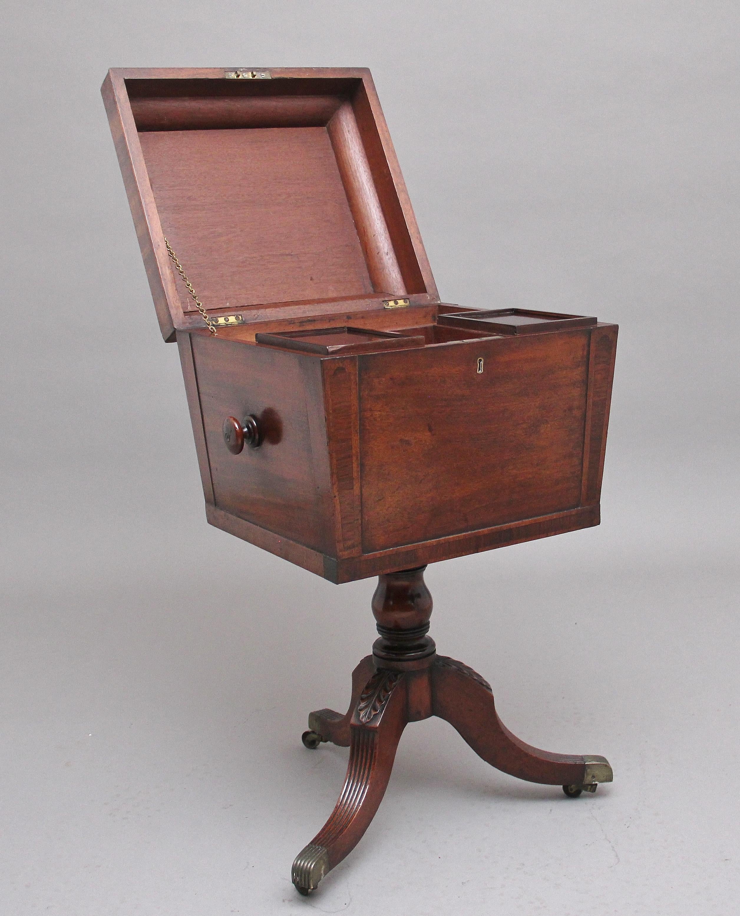 Early 19th century mahogany teapoy, the shaped, crossbanded and hinged top opening to reveal two wooden containers with lids, with two compartment spaces ideal for storage, the sides of the teapoy having turned wooden knob handles for carrying,