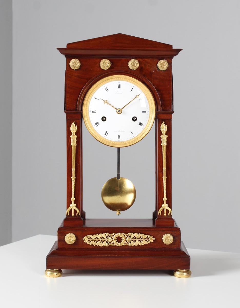 Antique French Pendulum, so-called portal clock

France (Paris)
Wood, bronze, enamel
Empire around 1810

Dimensions: H x W x D: 44 x 26 x 17 cm

Description:
Beautiful, strictly architecturally designed mantel clock, so-called portal