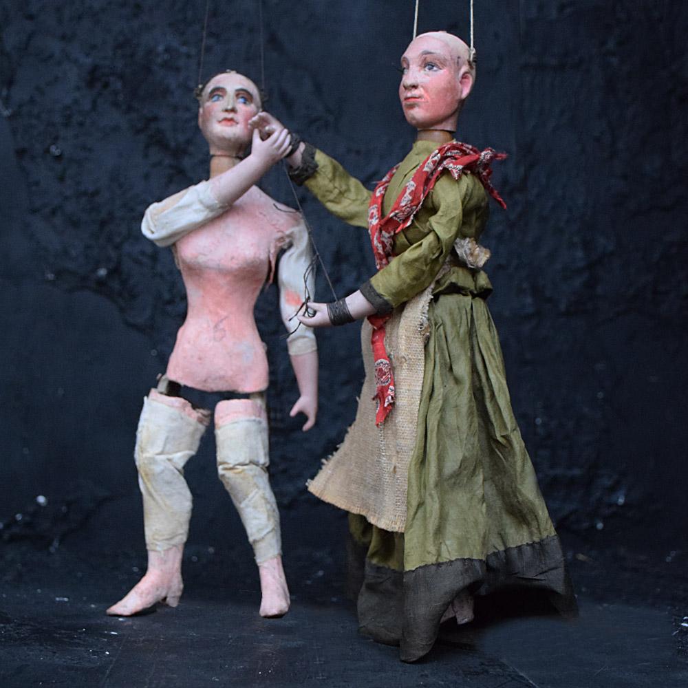 Early 19th Century Marionette Puppets    

A rare untouched example of two hand crafted early 19th century marionette puppets, likely to be French in origin. Their heads made from carved pine, porcelain arms and papier Mache bodies. One still