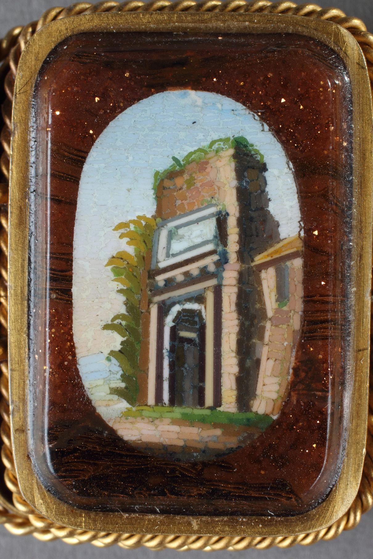 Gold bracelet, pearls, aventurine and micromosaics. The bracelet is decorated with seven rectangular medallions. Each medallion represents a view of a Roman monument such as the temples of Hercules Cori, the Vesta, the Sybille Tivoli but also the