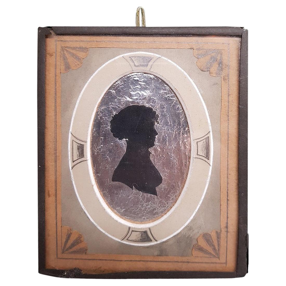 Early 19th Century Miniature Silhouette of a Lady on a Silver Paper Background For Sale