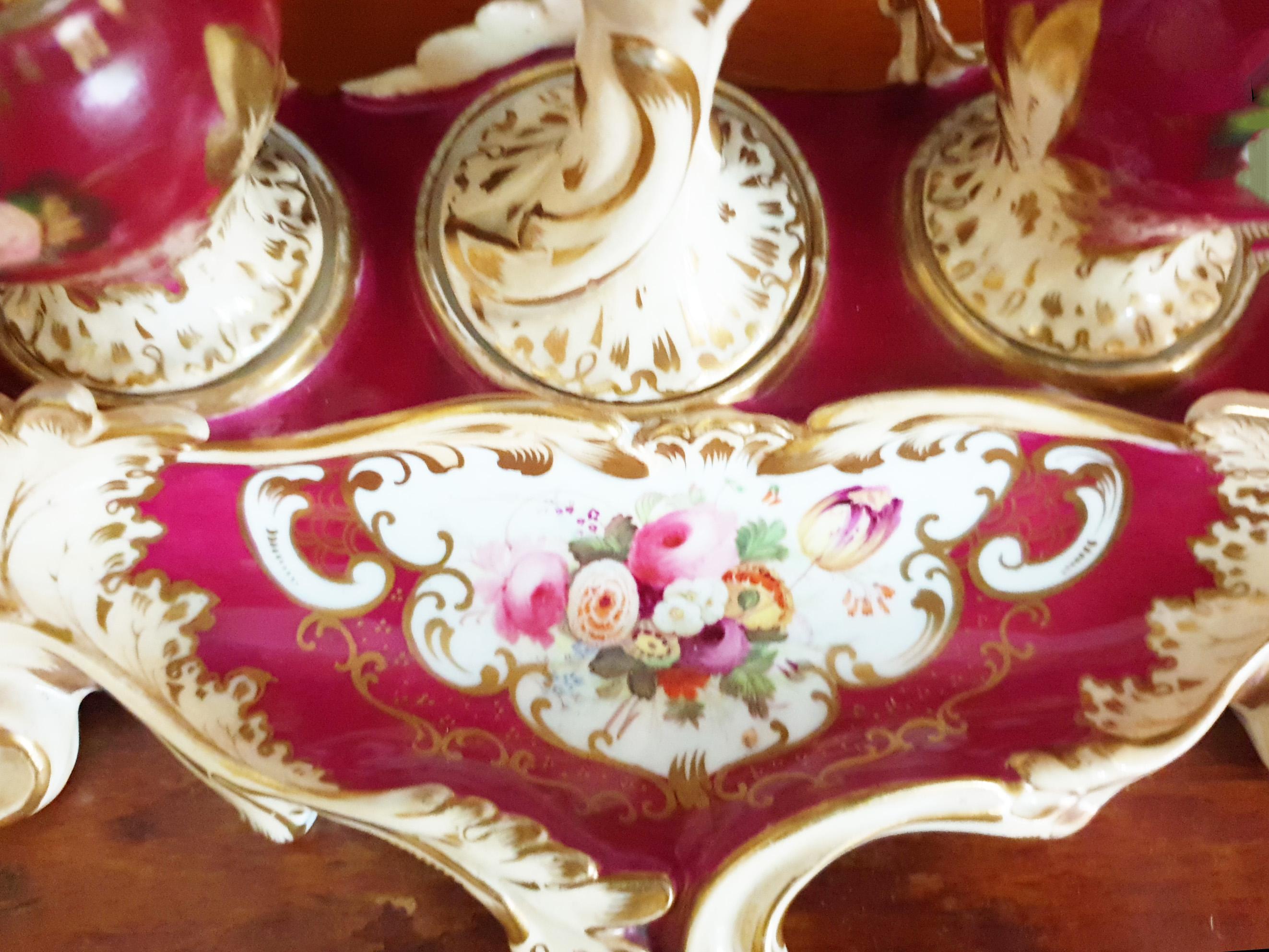 A beautiful and stunning hand painted Inkwell or Inkstand from circa 1840s from the Minton factory. It consists of four parts: the main body, two round lidded compartments and a candlestick to the middle. This Inkwell is painted in ruby red and