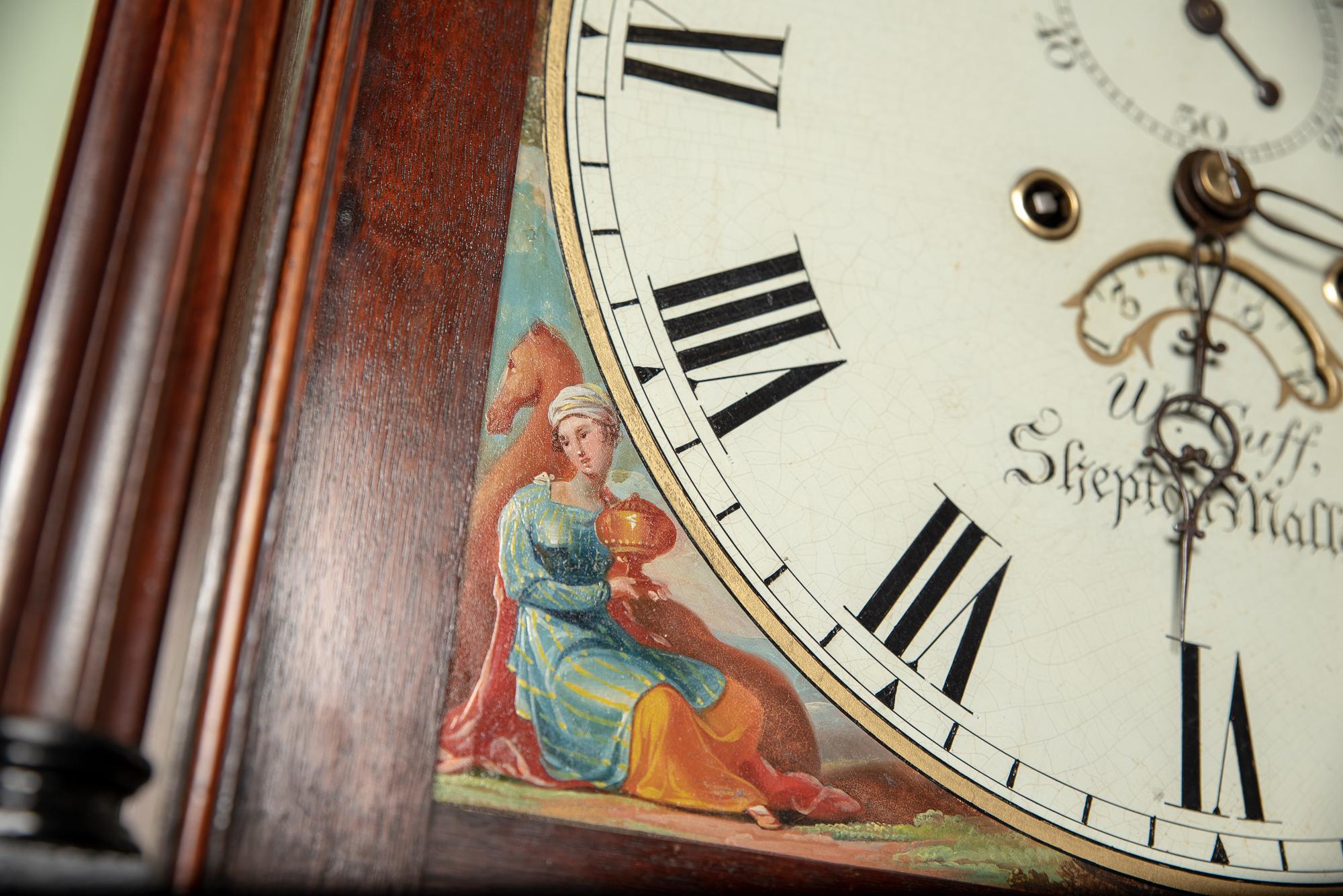 A very good 8 day striking the hours arched painted dial moon phase clock, depicting the four continents of the British Empire.
The maker William Cuff of High St, Shepton Mallet recorded working 1783-1837.
The case is of flame mahogany with ebony
