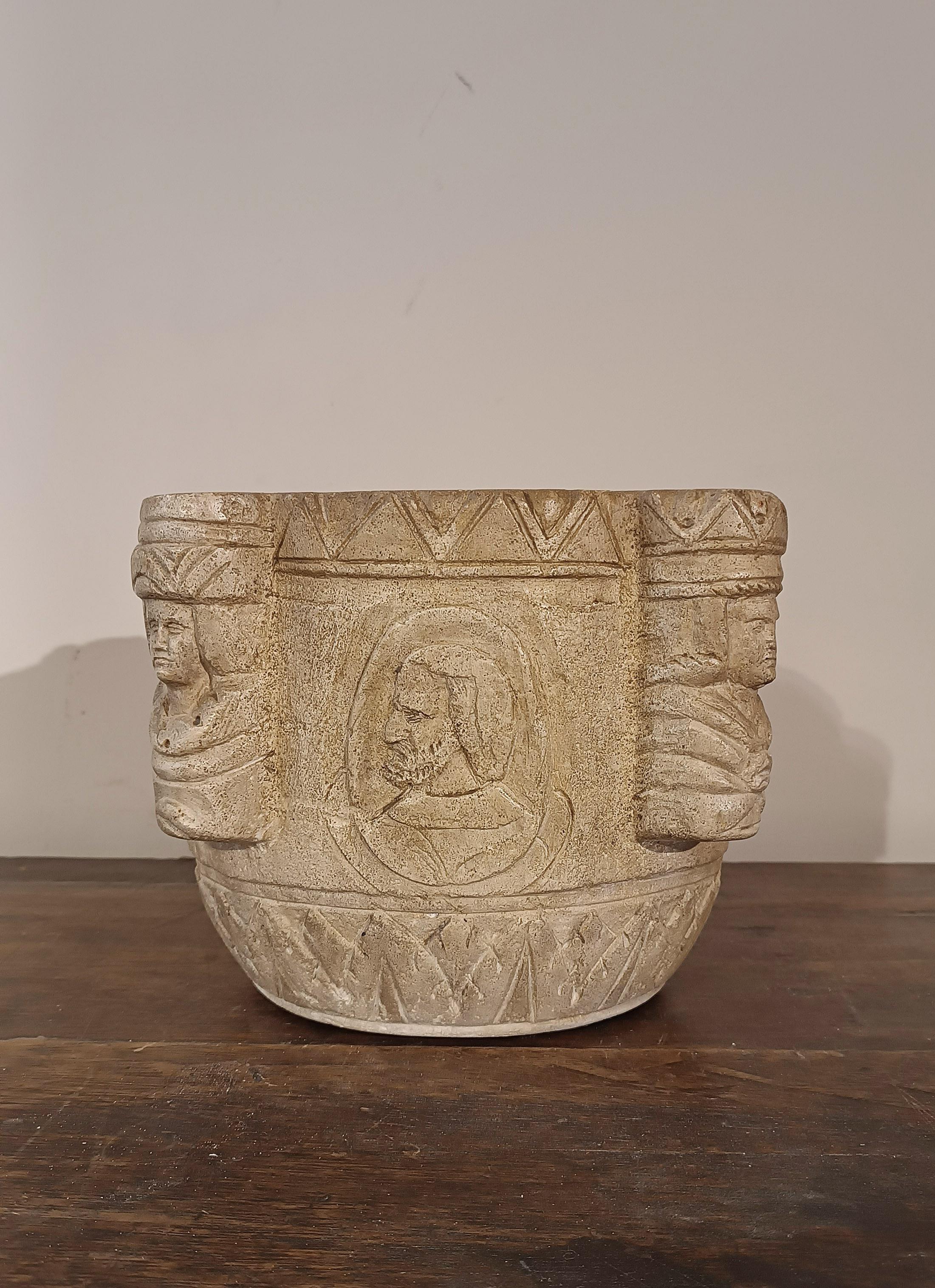 Beautiful Istrian stone mortar, decorated with Byzantine-inspired figurative engravings. Each side of the mortar features busts of elegantly dressed noble figures, alternating between young and elderly male and female figures. The corners are also