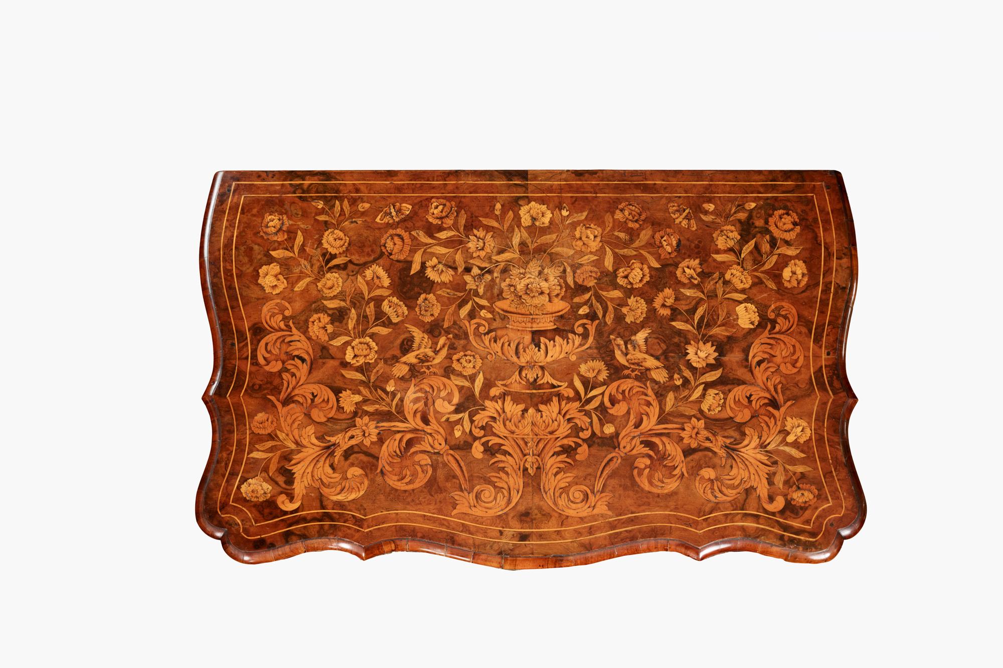 Early 19th Century neat sized Dutch walnut marquetry bombe chest, with serpentine front and canted corners. Elaborate floral marquetry inlay covers this entire piece with similar floral whiplash designs applied to the brass handles and escutcheons