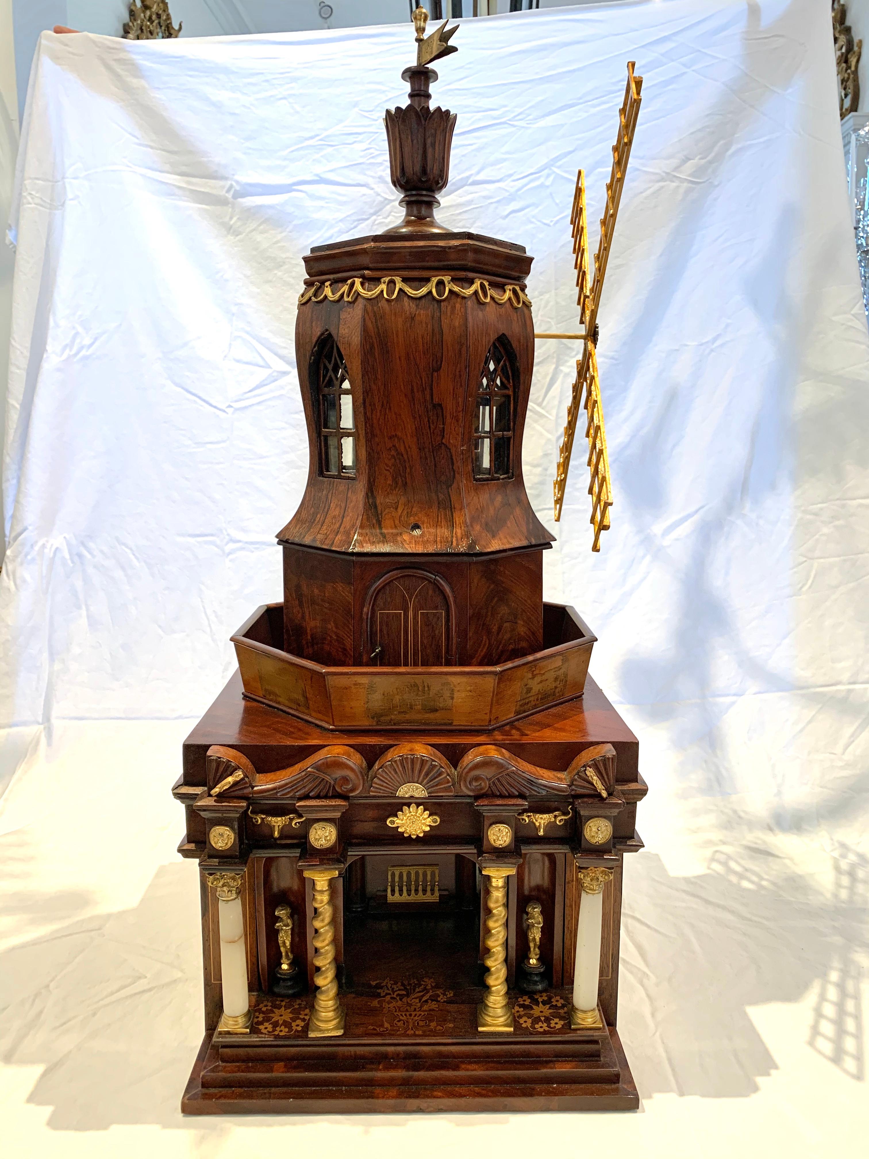 Rare early 19th century working automaton sewing box with hidden compartments for necessaries and sewing implements. Original handmade clockwork inside which operates a working windmill. Ormolu mounts and neoclassical temple structure. Stairs