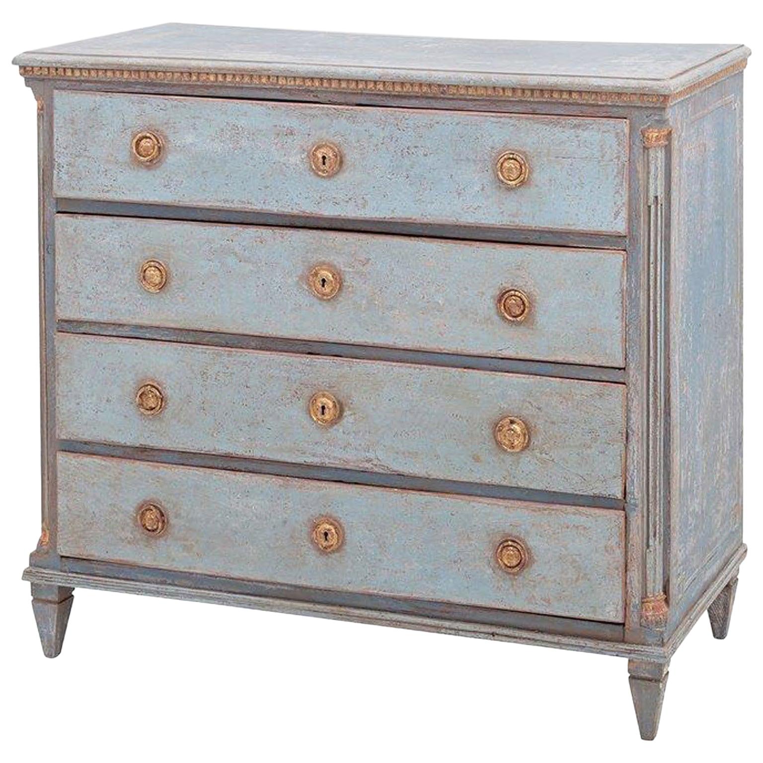 A light-blue, grey antique Swedish Gustavian commode made of hand carved painted Pinewood, in good condition. The rectangular Scandinavian chest is composed with four large drawers, standing on four short tapered feet. The cabinet is enhanced by