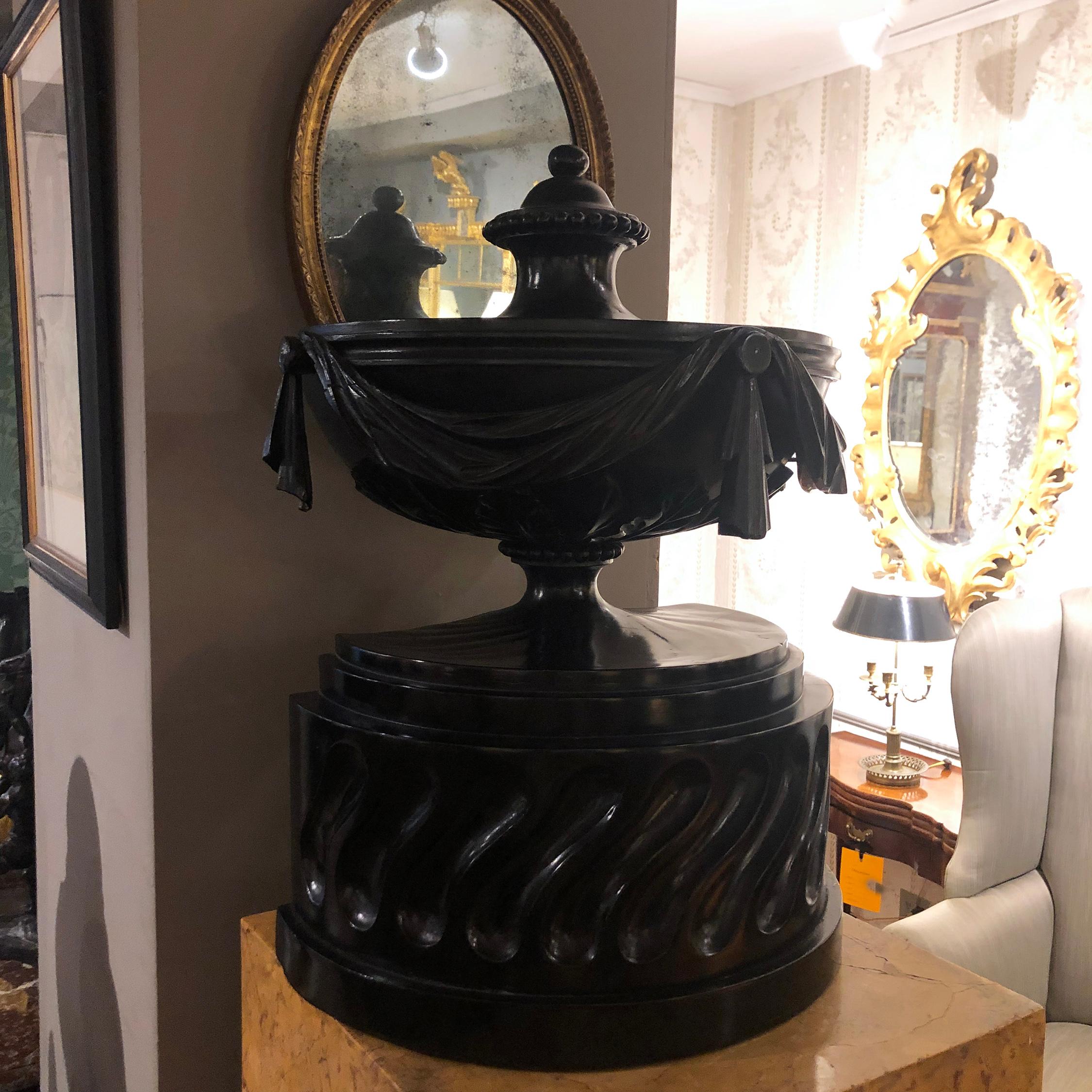 Early 19th century neoclassical carved and ebonized wooden urn.
  