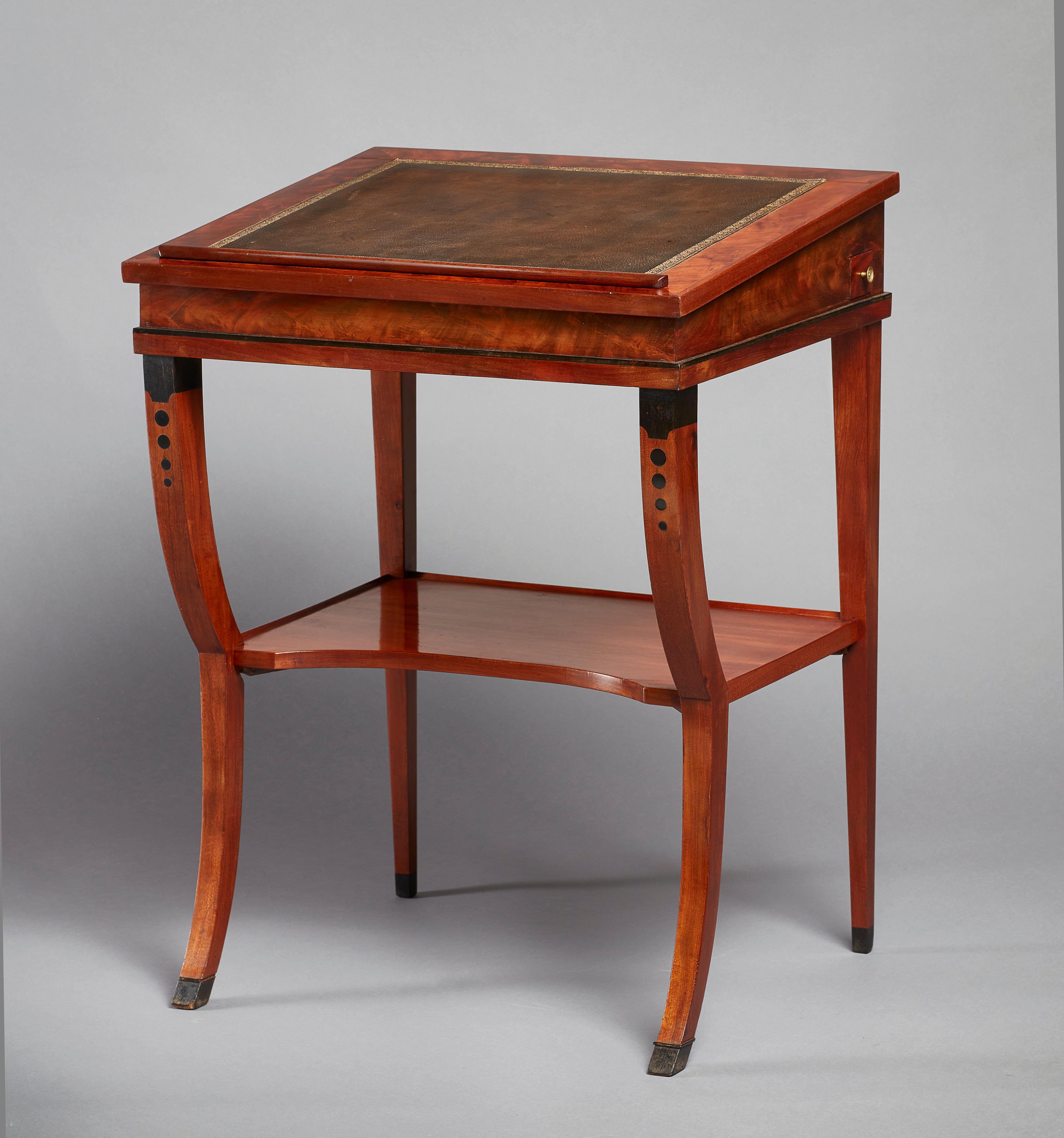 A rare early 19th century neoclassical mahogany double ratcheted reading-cum-drawing-table. The slightly sloped top with an inset tooled leather writing surface. The double ratcheted top turns this elegant reading table into a standing desk. With