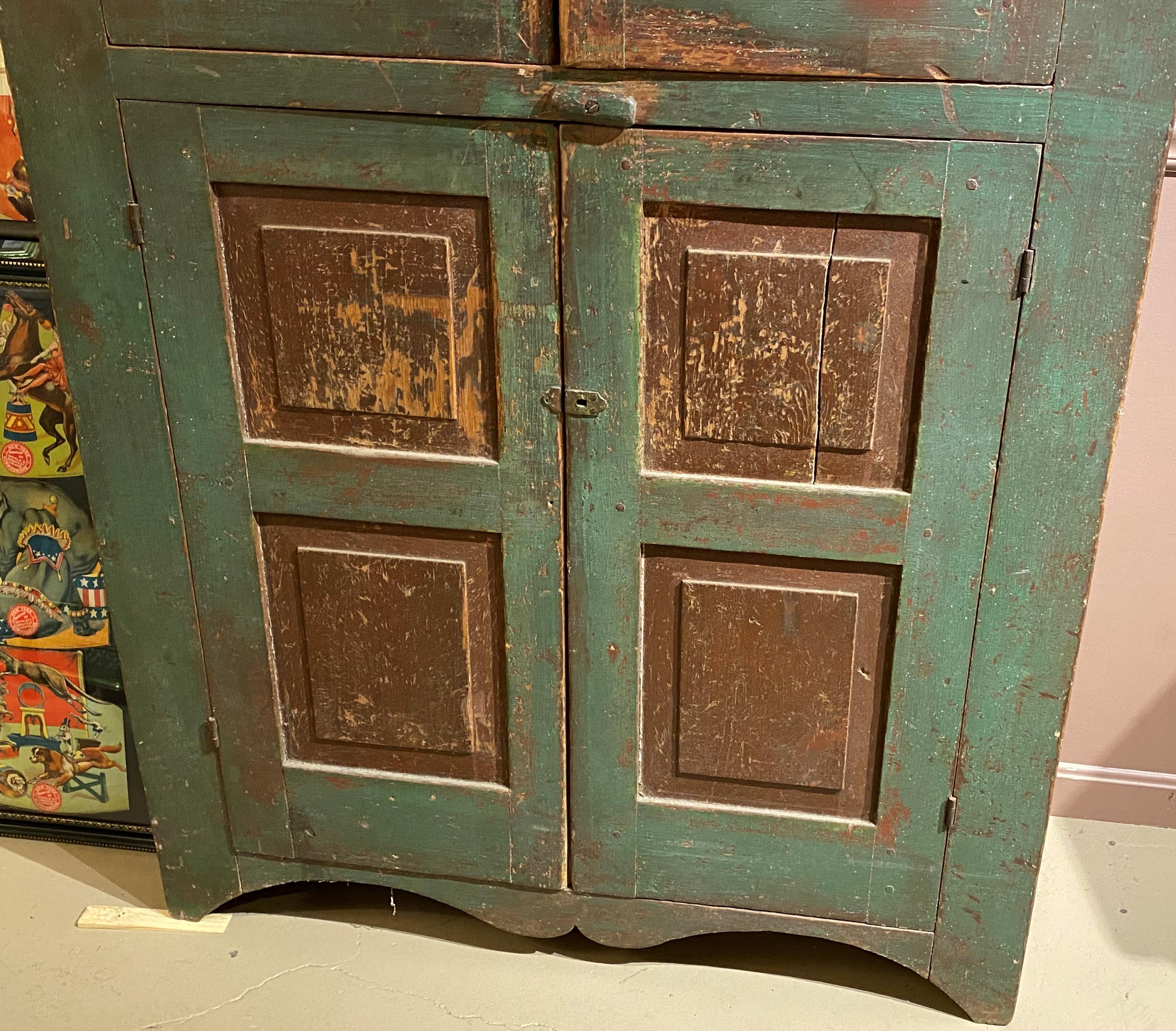 Hand-Carved Early 19th Century New England Paneled Cupboard in Green & Reddish Brown Paint For Sale