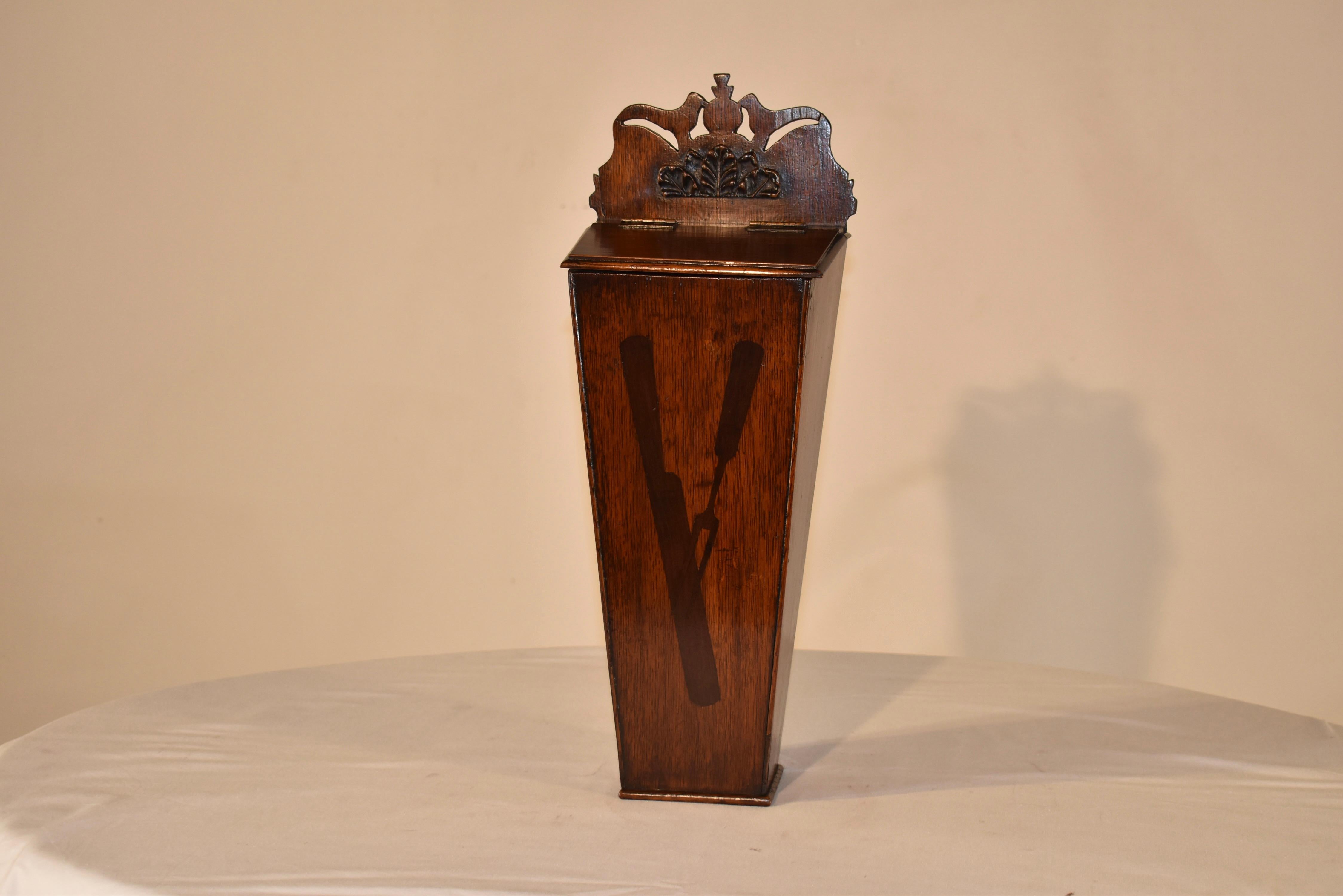 Early 19th century oak candle box from England.  The box has a wonderfully hand carved top with two opposing birds flanking a central pineapple.  These symbols were also synonymous with welcoming guests into your home.  Below the birds, there is a