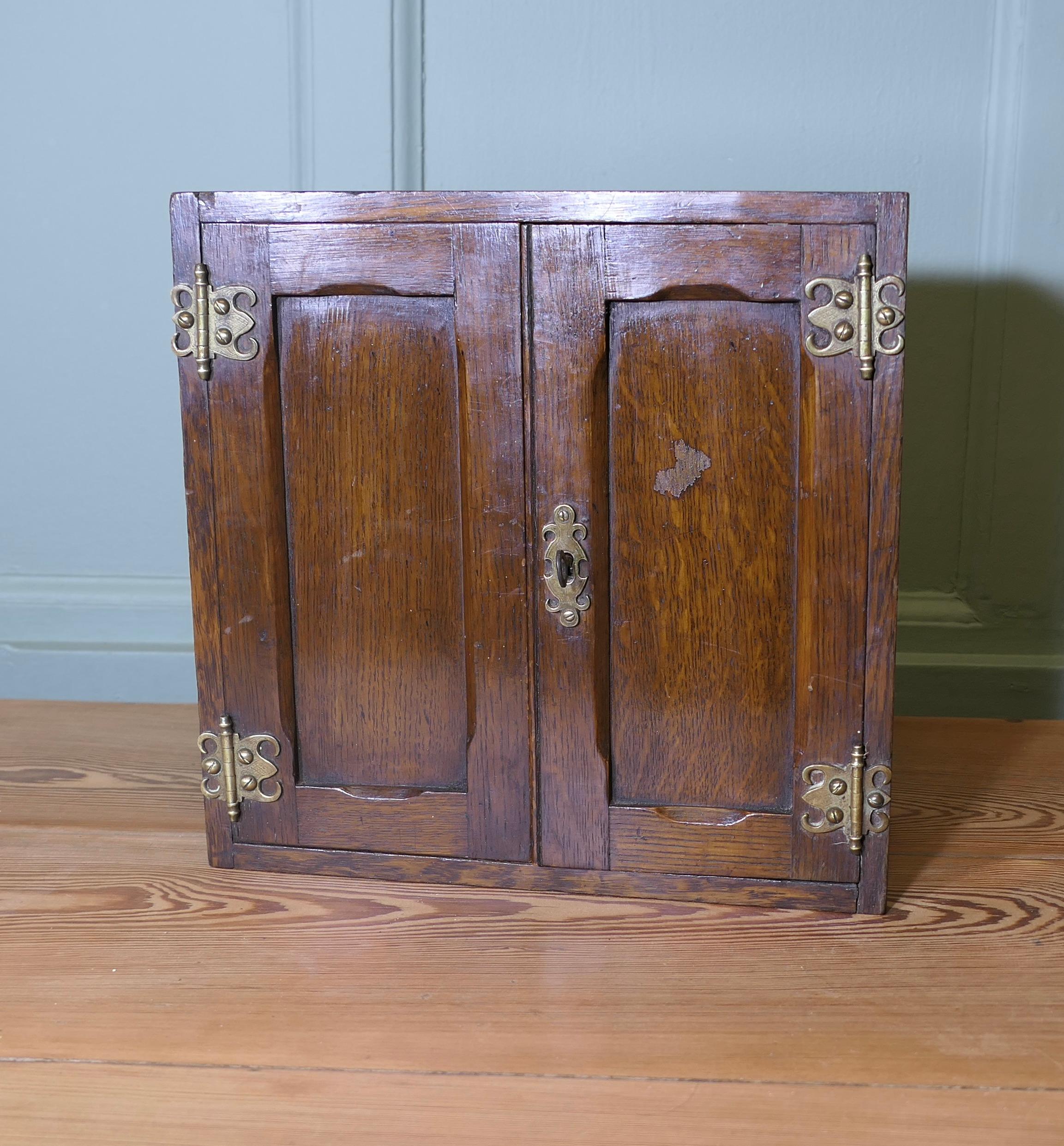 Early 19th century Oak Cupboard 

A very attractive piece with 2 doors a shelf inside and a working lock and key

The cupboard is 12” high, 6” deep, 12” wide
WE118