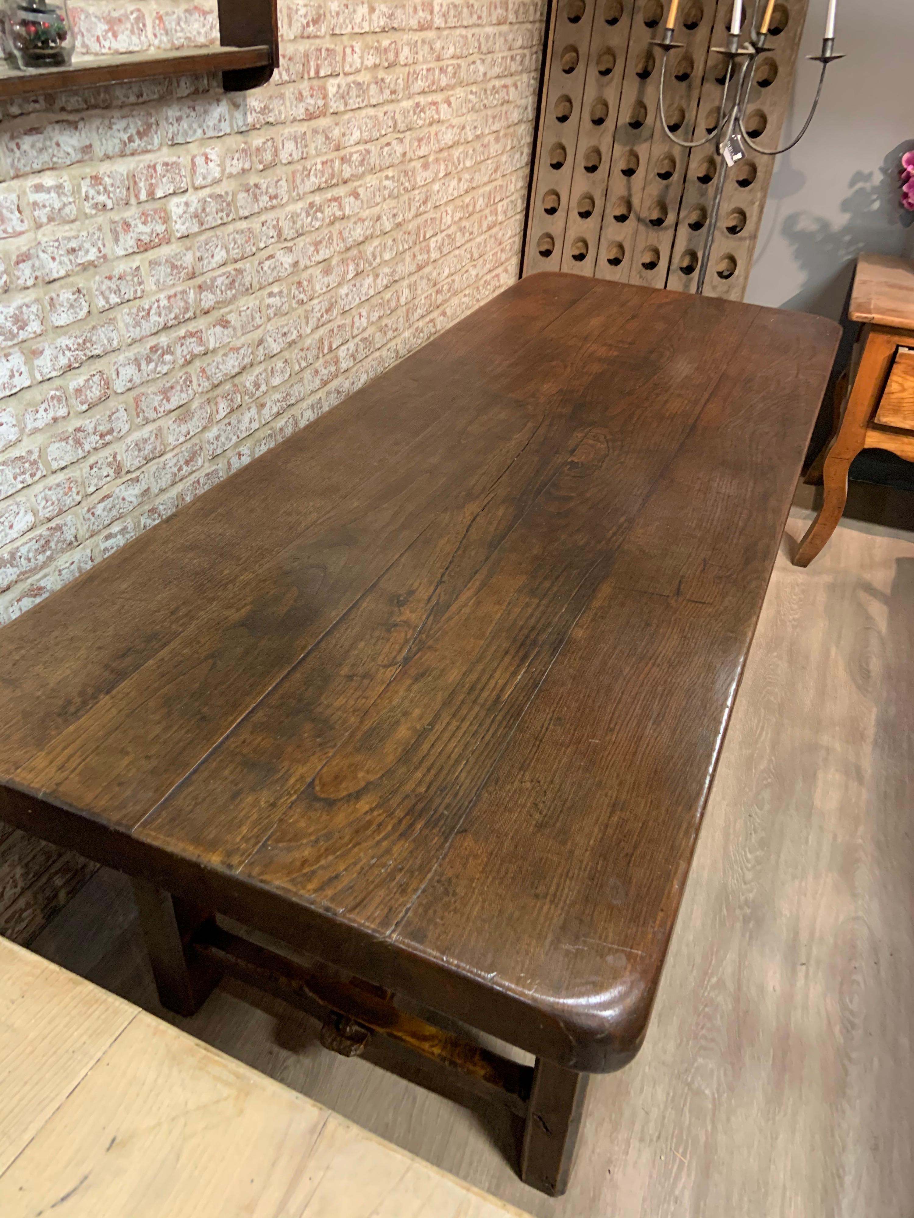 Late 19th century oak farmhouse table with centre stretcher and side end stretchers. 3” thick rounded top fabulous color and patination. Plenty of leg room and a very comfortable table to be seated at.